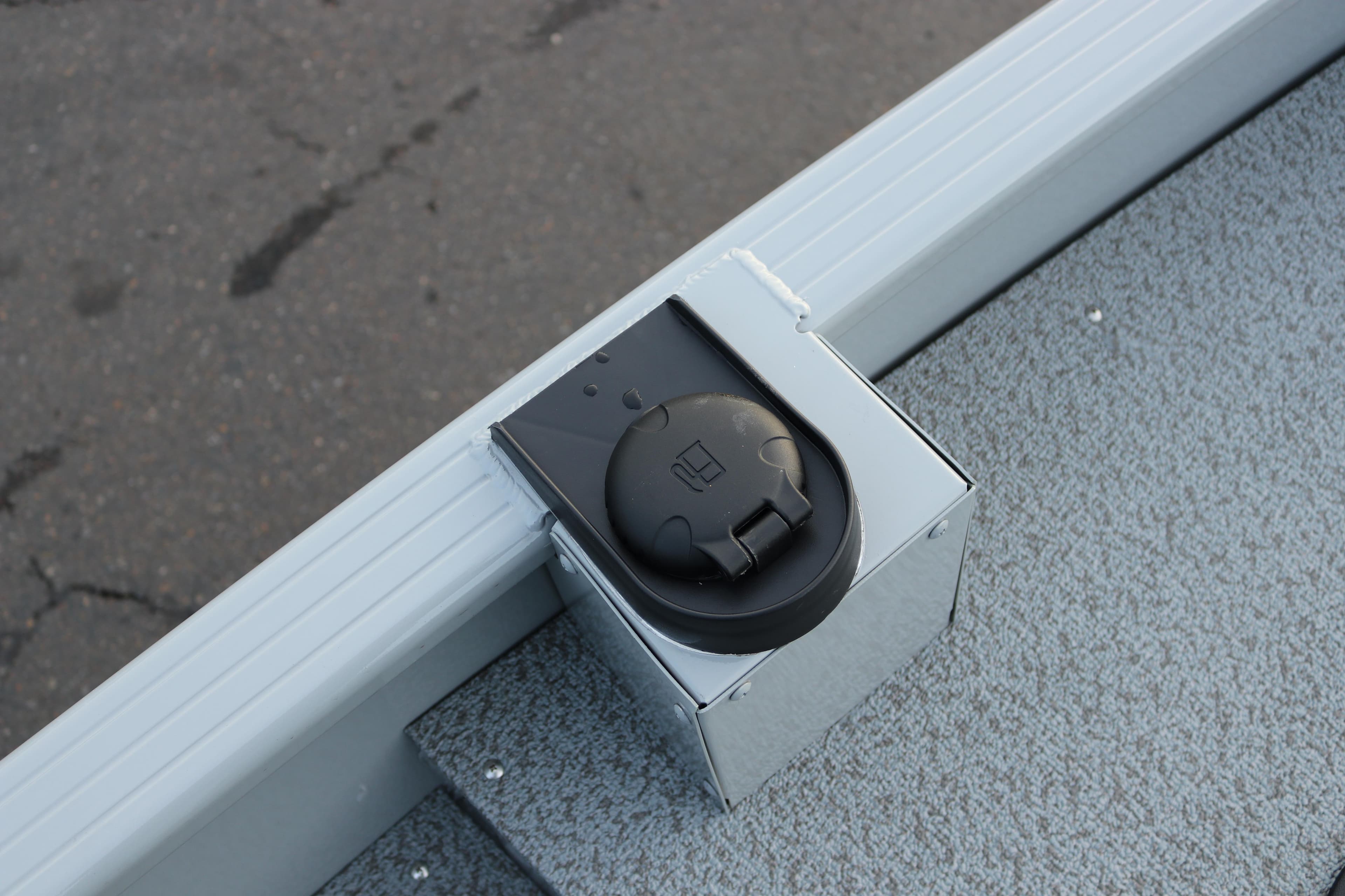 2026 Smoker Craft Sportsman 1660 boat detail, featuring a black electrical outlet on a gray surface.
