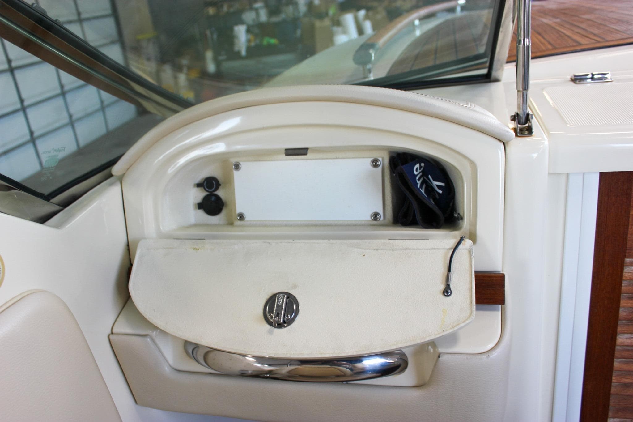 2011 Chris-Craft Corsair 28 dashboard with storage compartment and accessories.