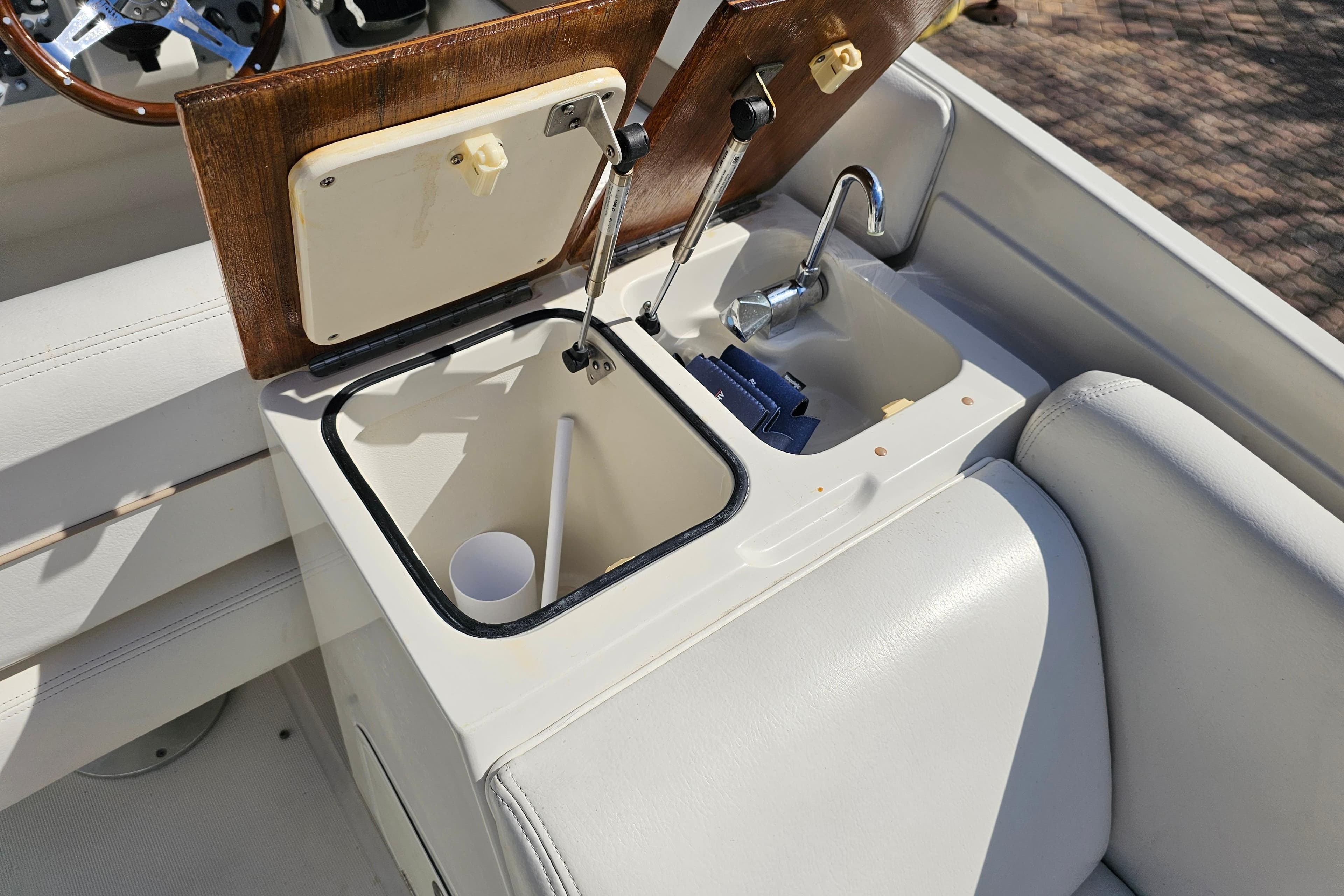 2003 Chris-Craft Launch 28 boat interior with sink and storage compartment.