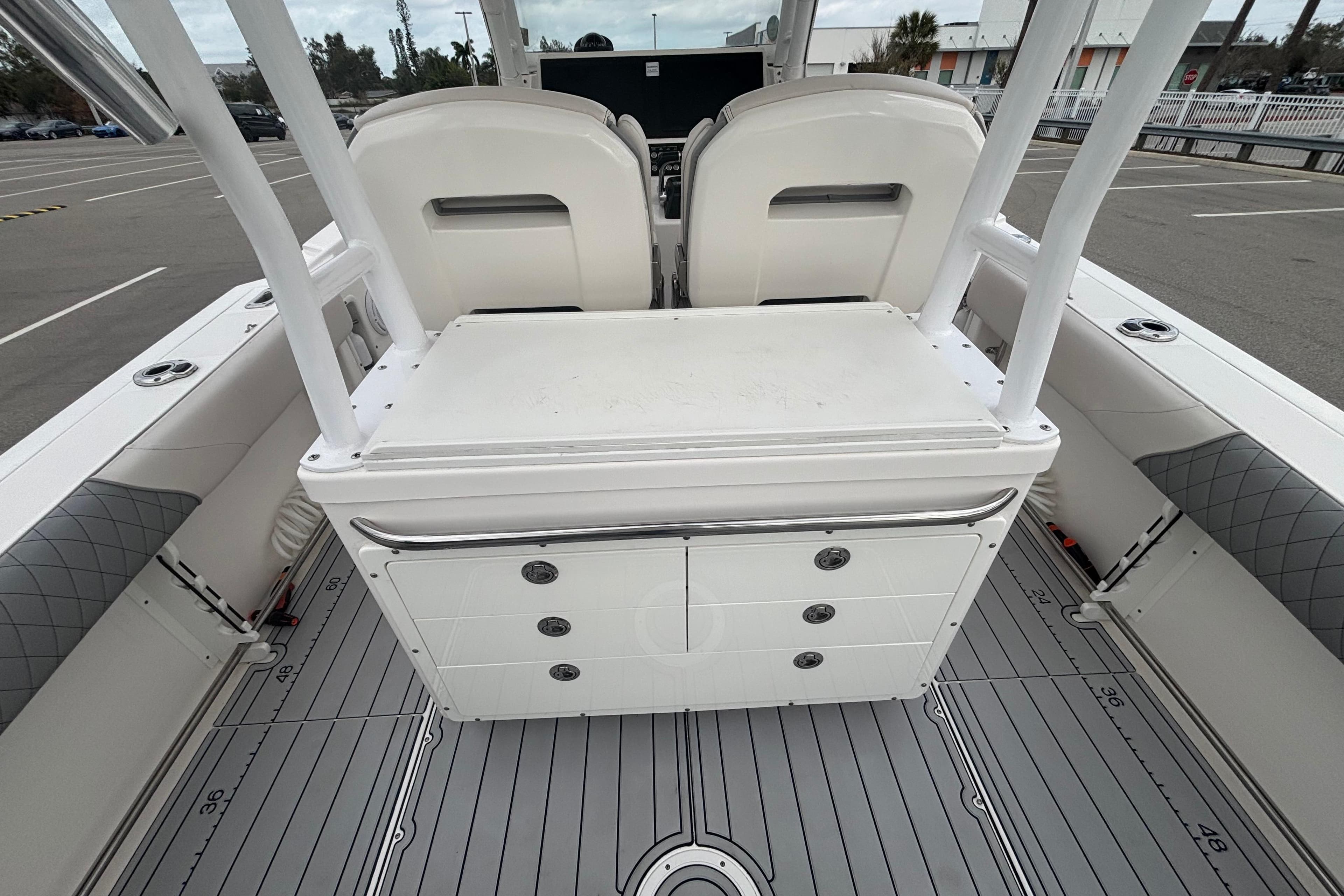 2015 Edgewater 320CC boat interior with seating and storage compartments.