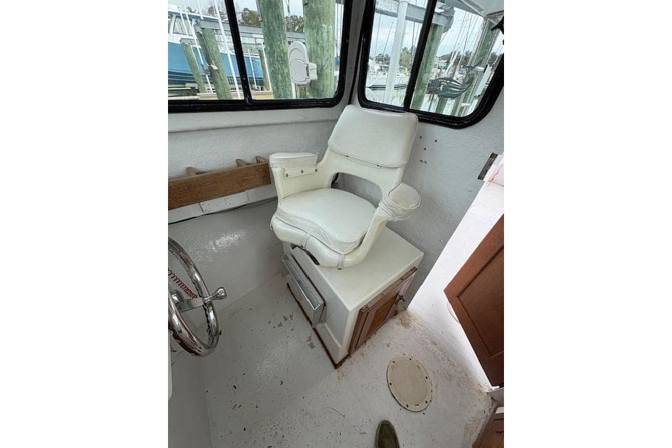 1989 C-Hawk 29 Sport Cabin interior with white captain's chair and steering wheel.