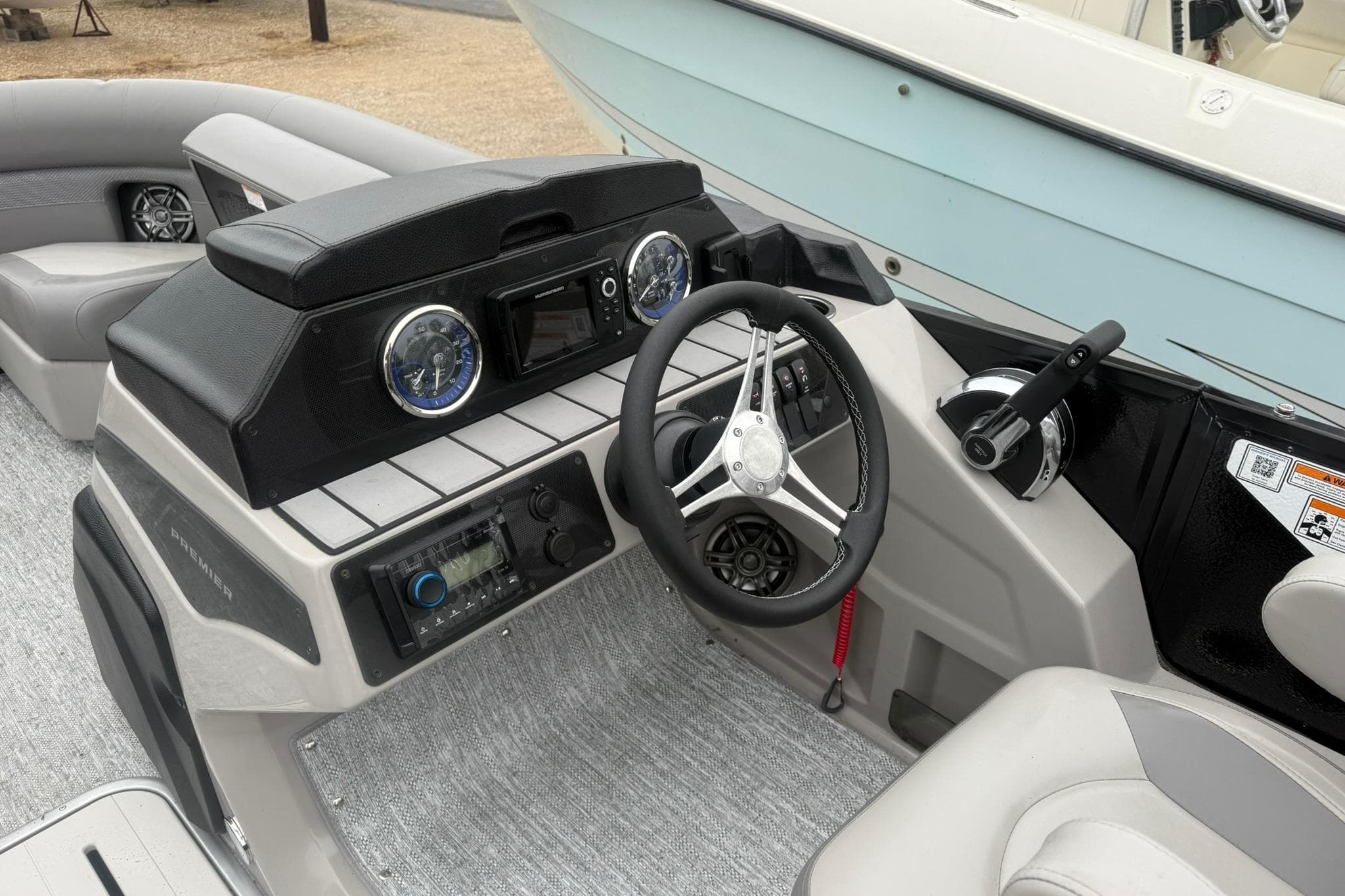 2026 Premier 210 Sunsation RL Tritoon dashboard with steering wheel and controls.