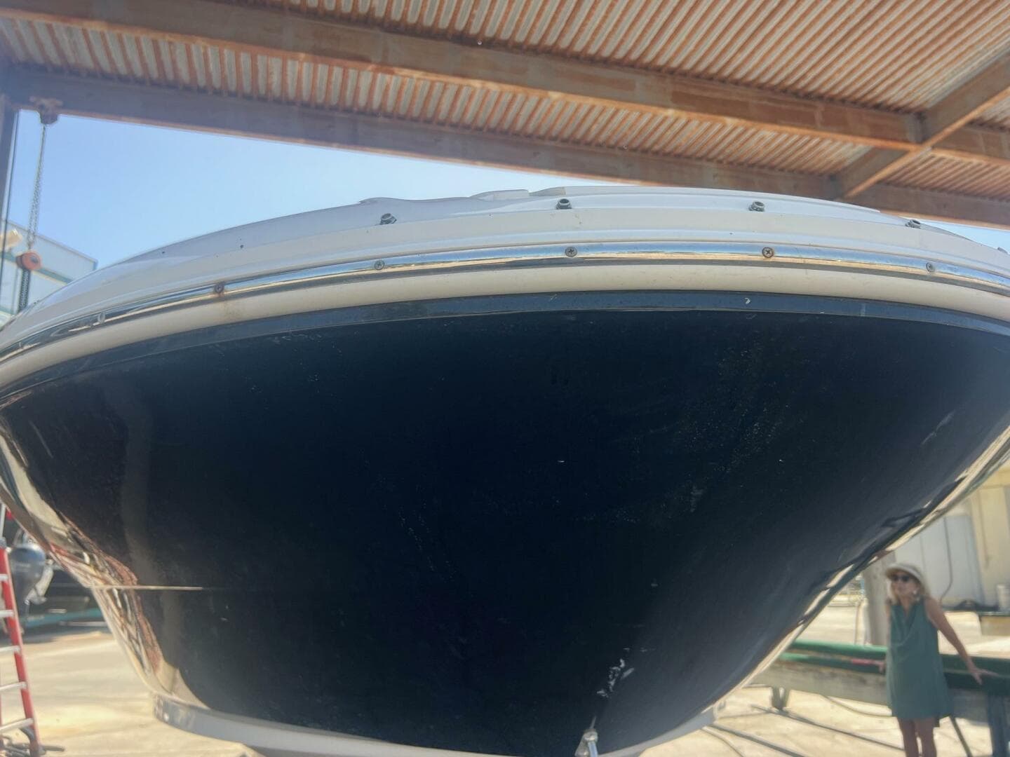 2007 Sea Ray 240 Sundeck boat under a metal roof, viewed from the front.