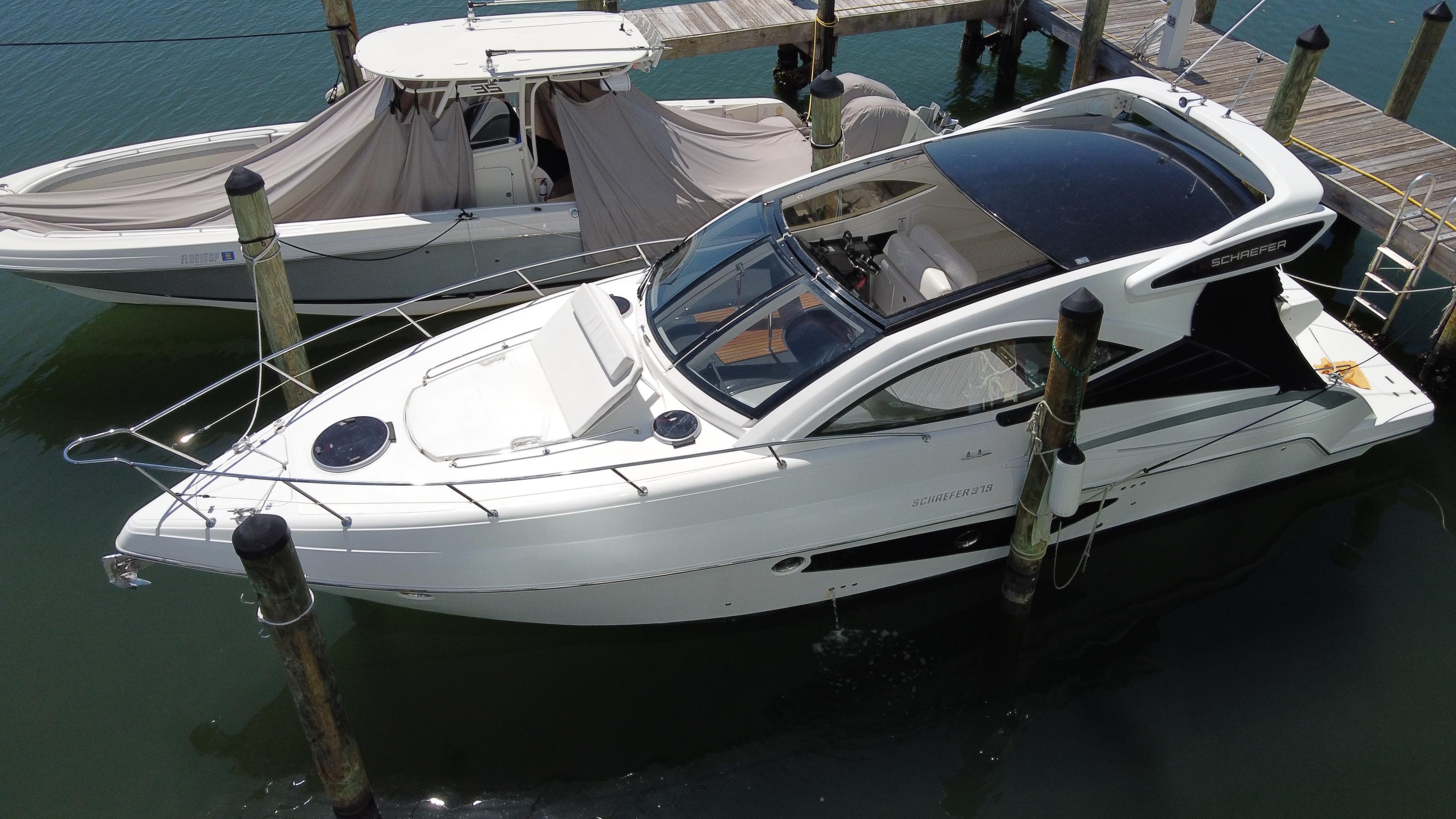 2023 Schaefer 375 HT yacht docked at marina, aerial view.