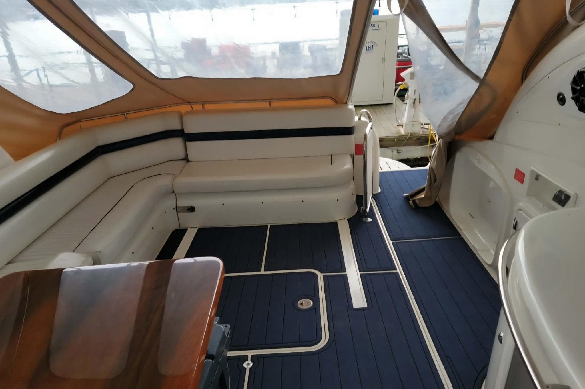 2004 Sunseeker Predator 56 yacht interior with cushioned seating and sleek design.