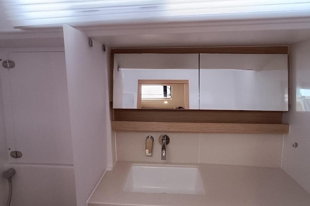 2024 Dufour 470 yacht bathroom with modern sink and mirrored cabinet.