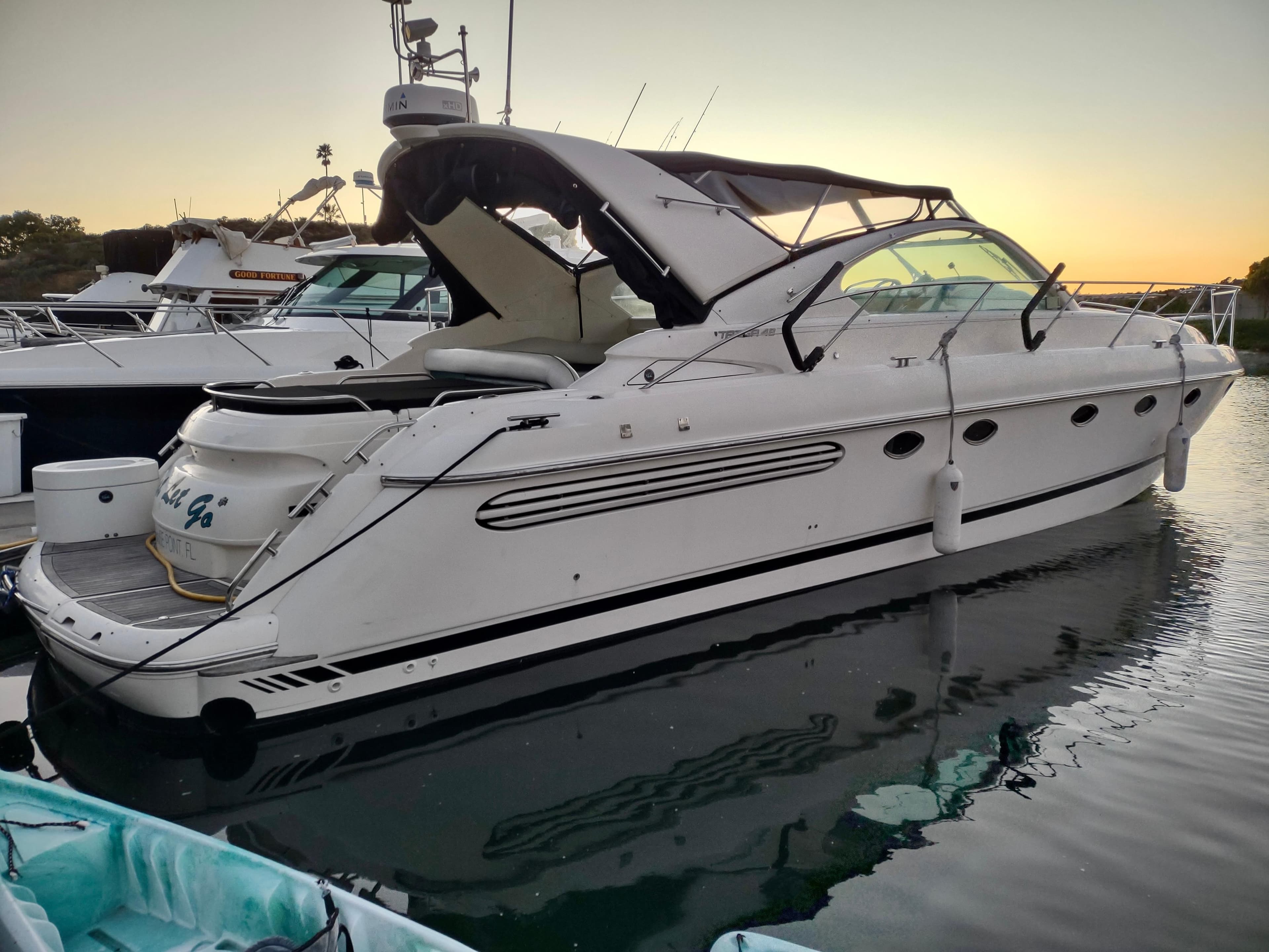 1999 Fairline Targa 48 Open yacht docked at sunset, featuring sleek design and modern amenities.