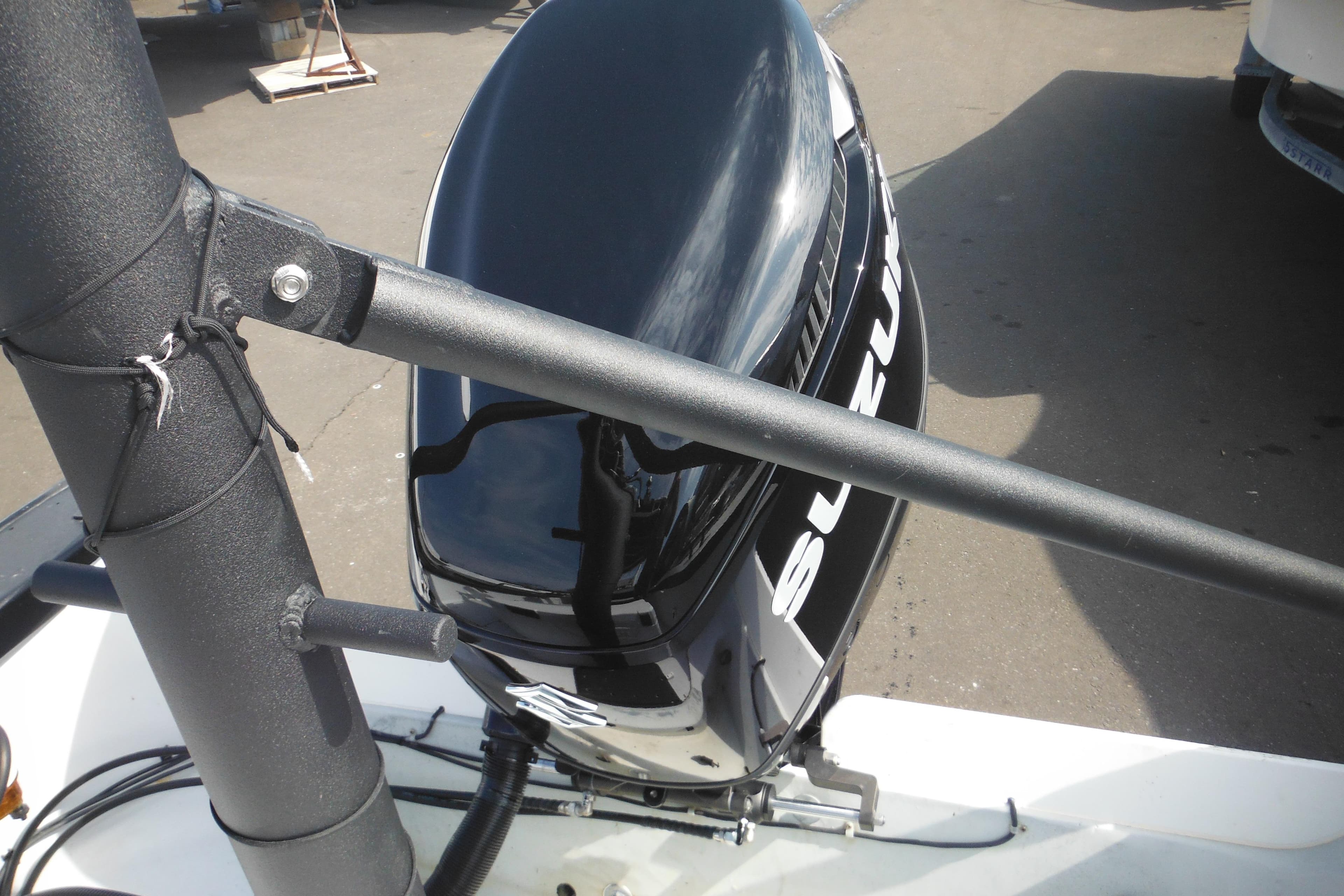 1990 Boston Whaler Guardian 22 with Suzuki outboard motor, docked on a sunny day.