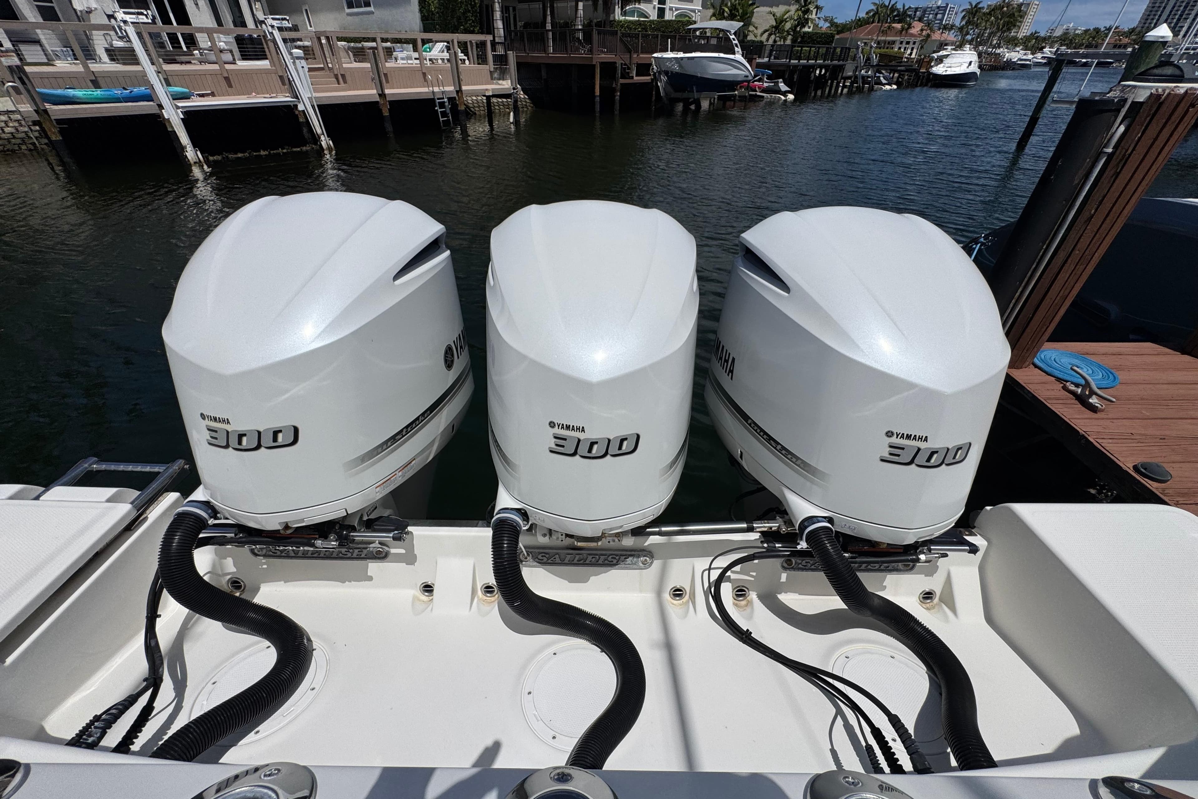 Triple Yamaha 300 engines on a 2019 Sailfish 360 CC boat docked by the waterfront.