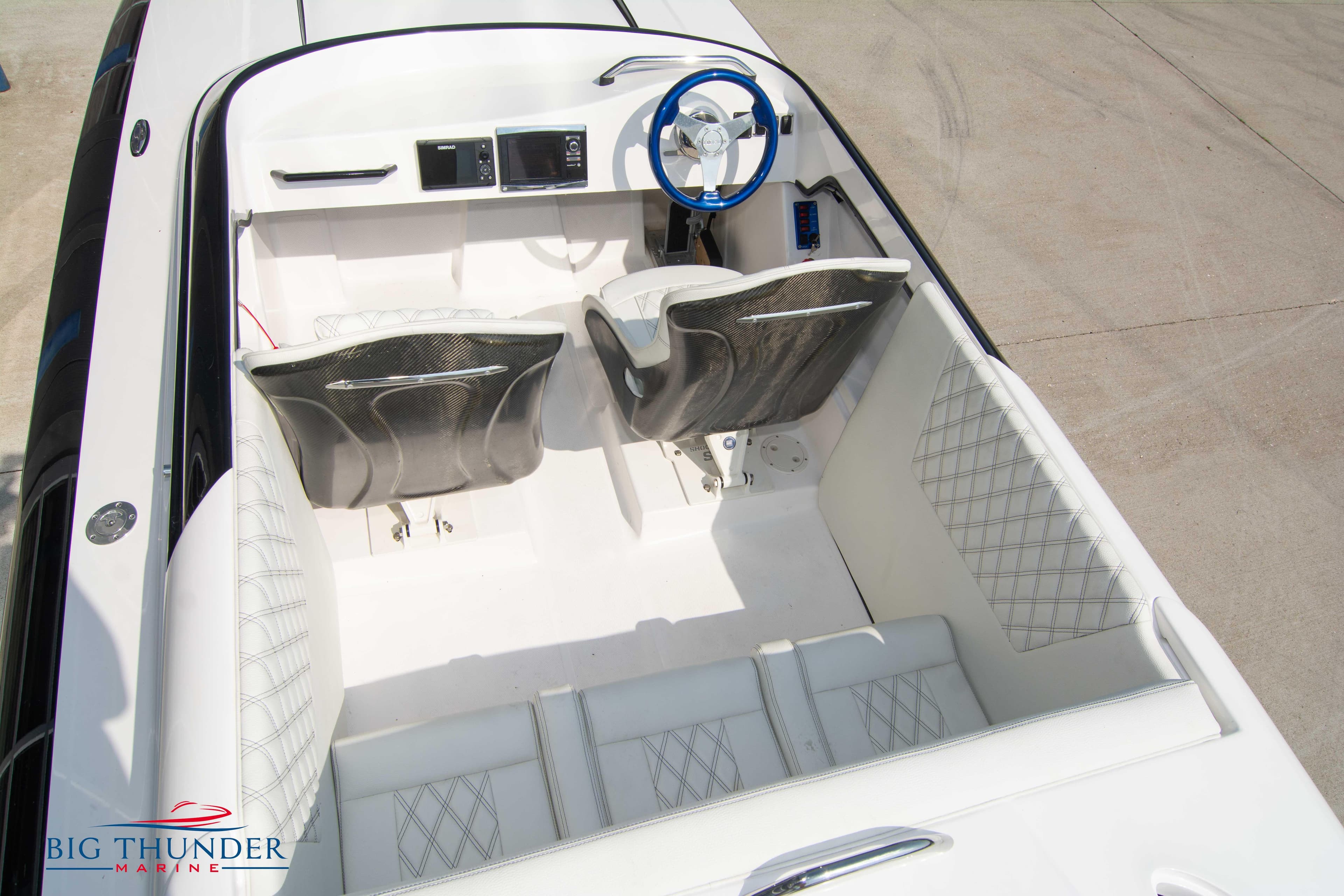 2019 Spectre Screaming Eagle 22 Talon boat interior with white seating and blue steering wheel.