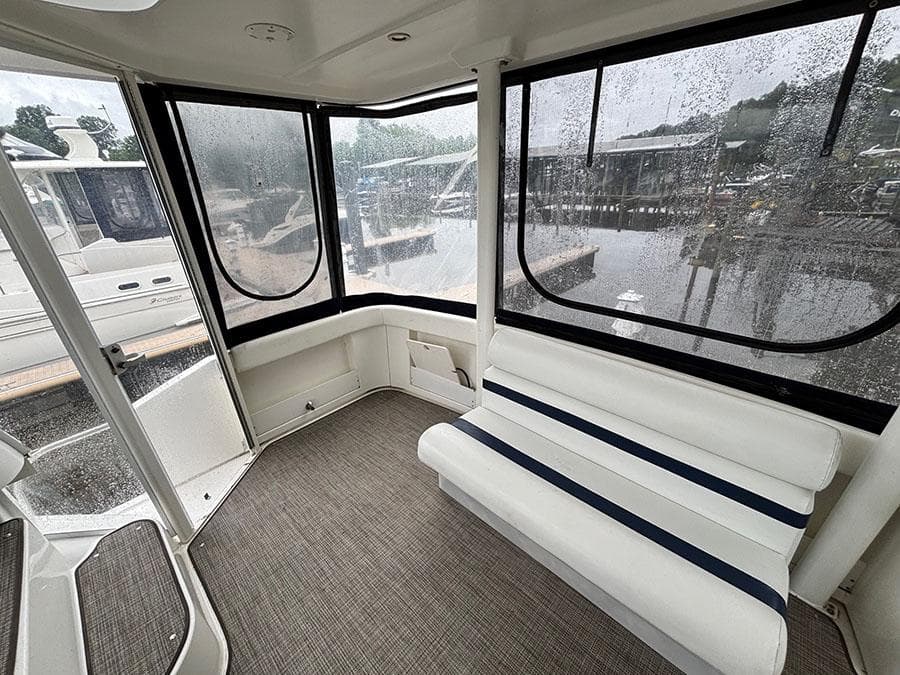 2004 Cruisers Yachts 375 Motoryacht interior with white seating and large windows.