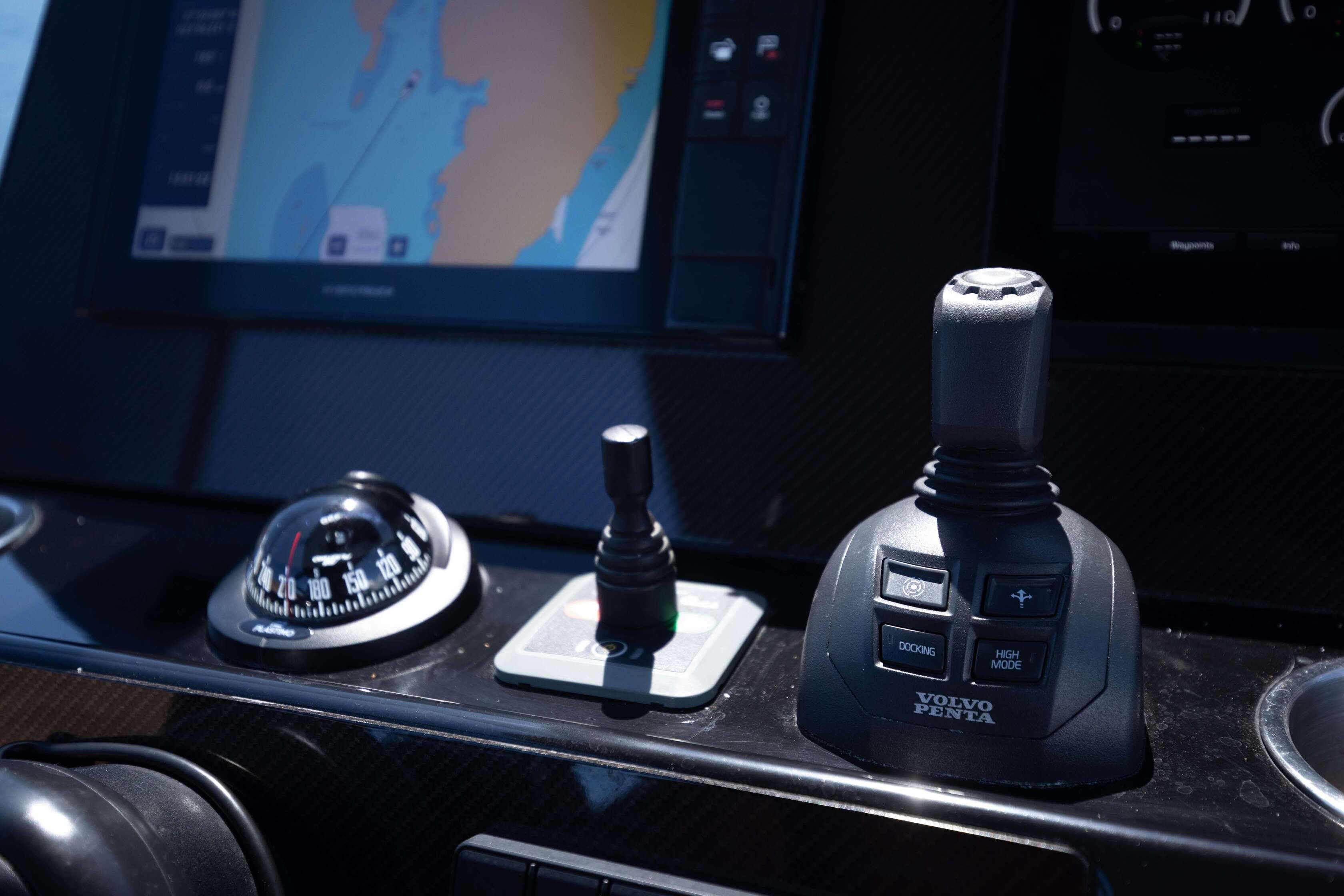 Control panel of 2021 Technohull Omega 47 with navigation and joystick controls.