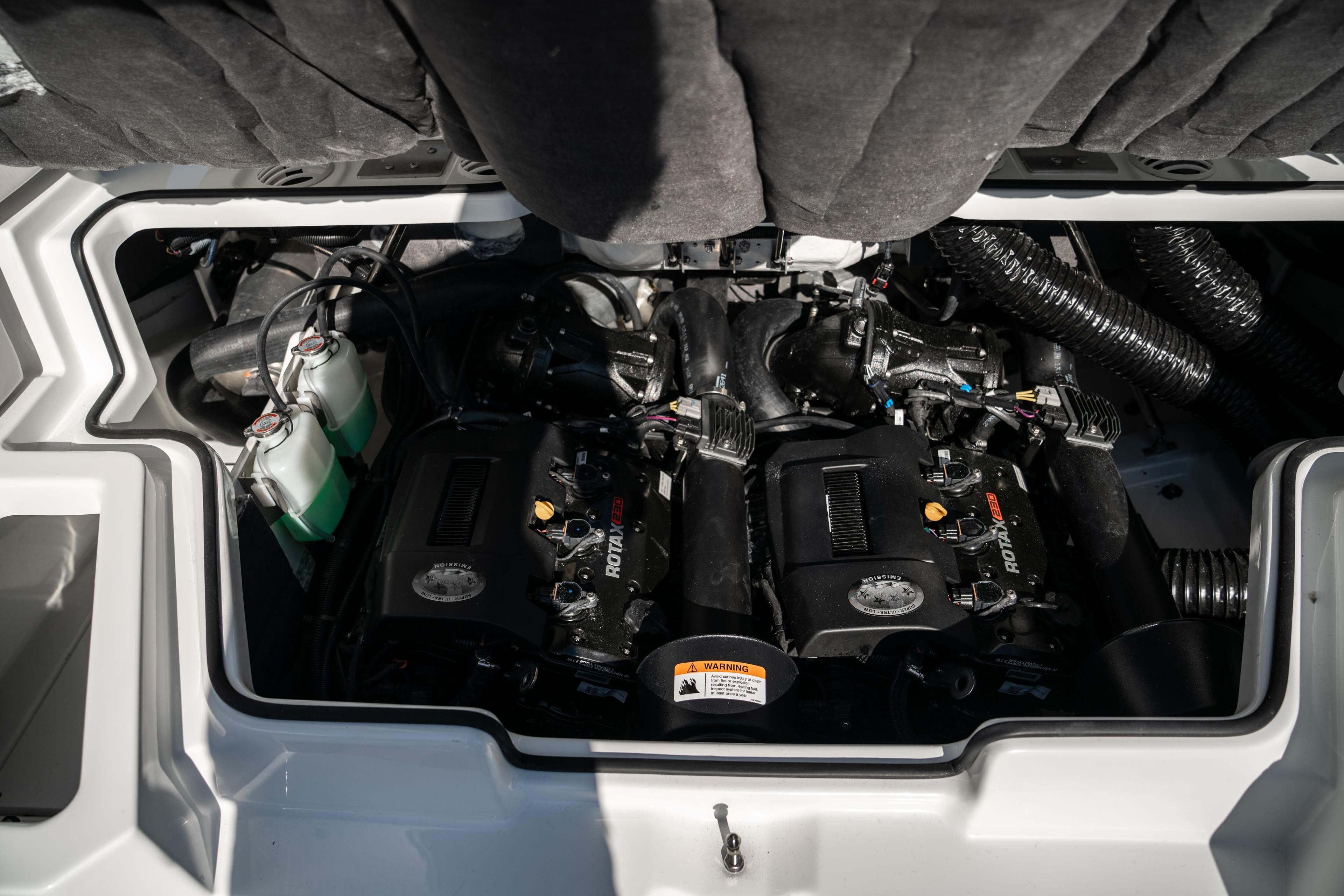 Engine compartment of a 2022 Scarab 255 boat with twin Rotax engines.