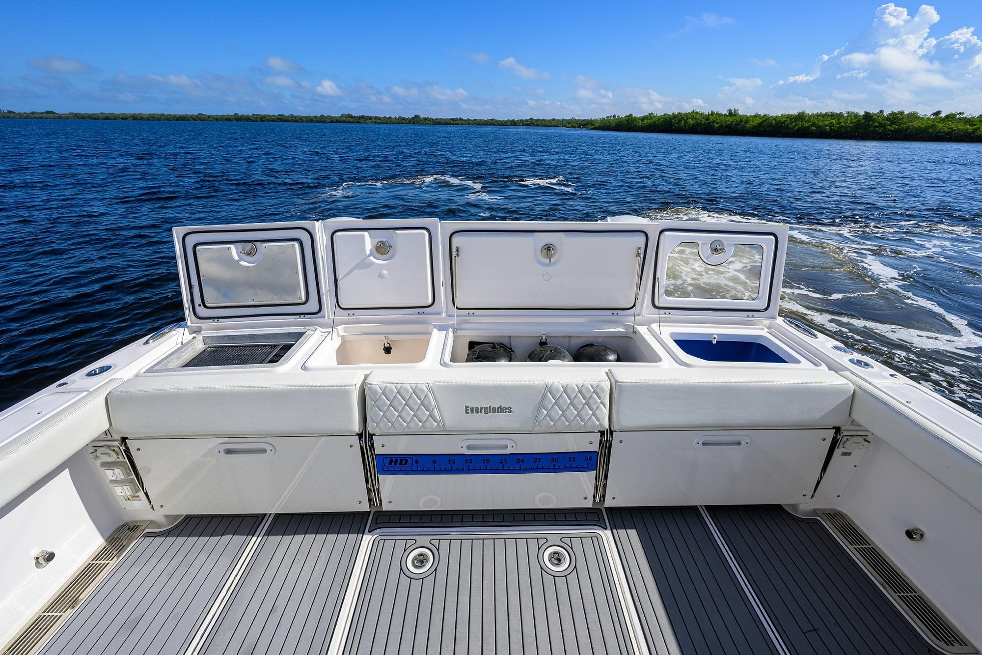 2024 Everglades 455 Center Console boat interior with open storage compartments on the water.