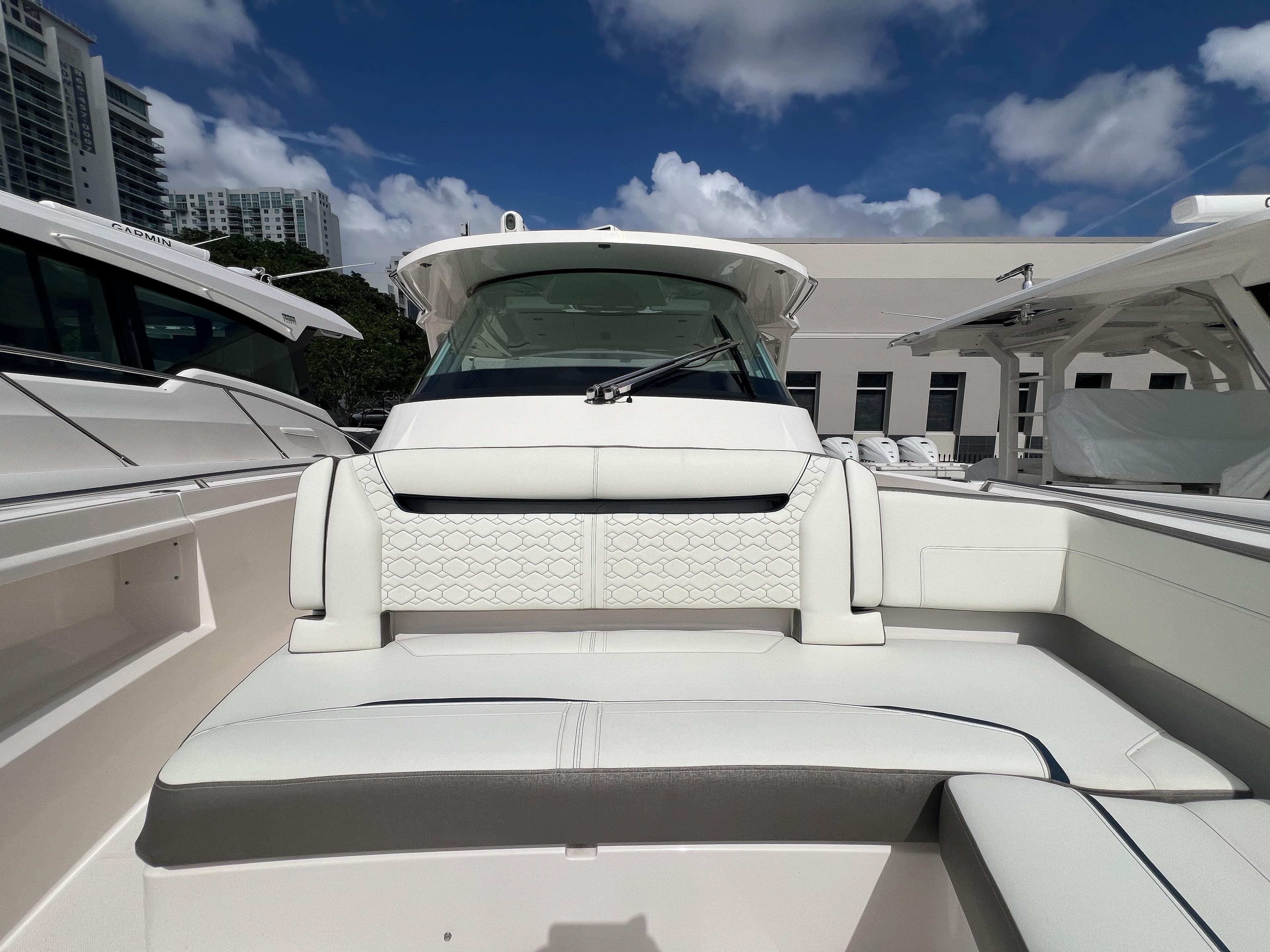 2023 Tiara Yachts 38 LS boat interior with white seating under a blue sky.
