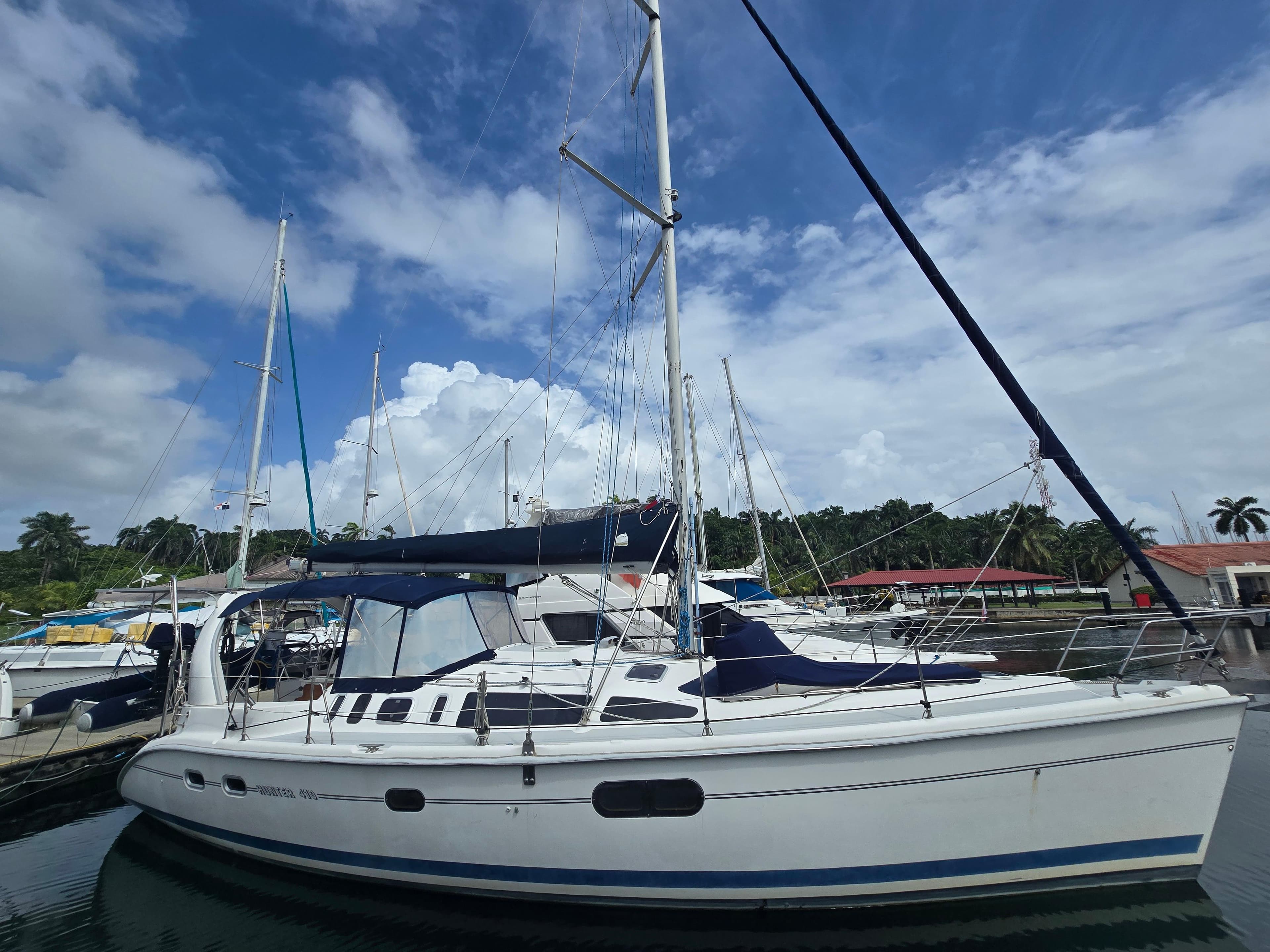 Sailboat docked at marina, 1998 Hunter 410 model under a blue sky.