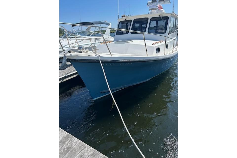 1998 Eastern 35 Casco Bay boat docked in marina, blue hull, sunny day.