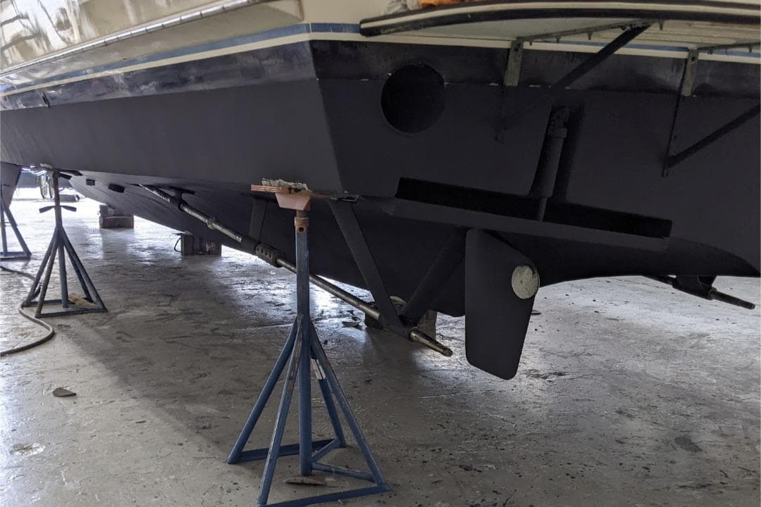 1984 Hatteras 53 Extended Deckhouse Motor Yacht on stands in a workshop.