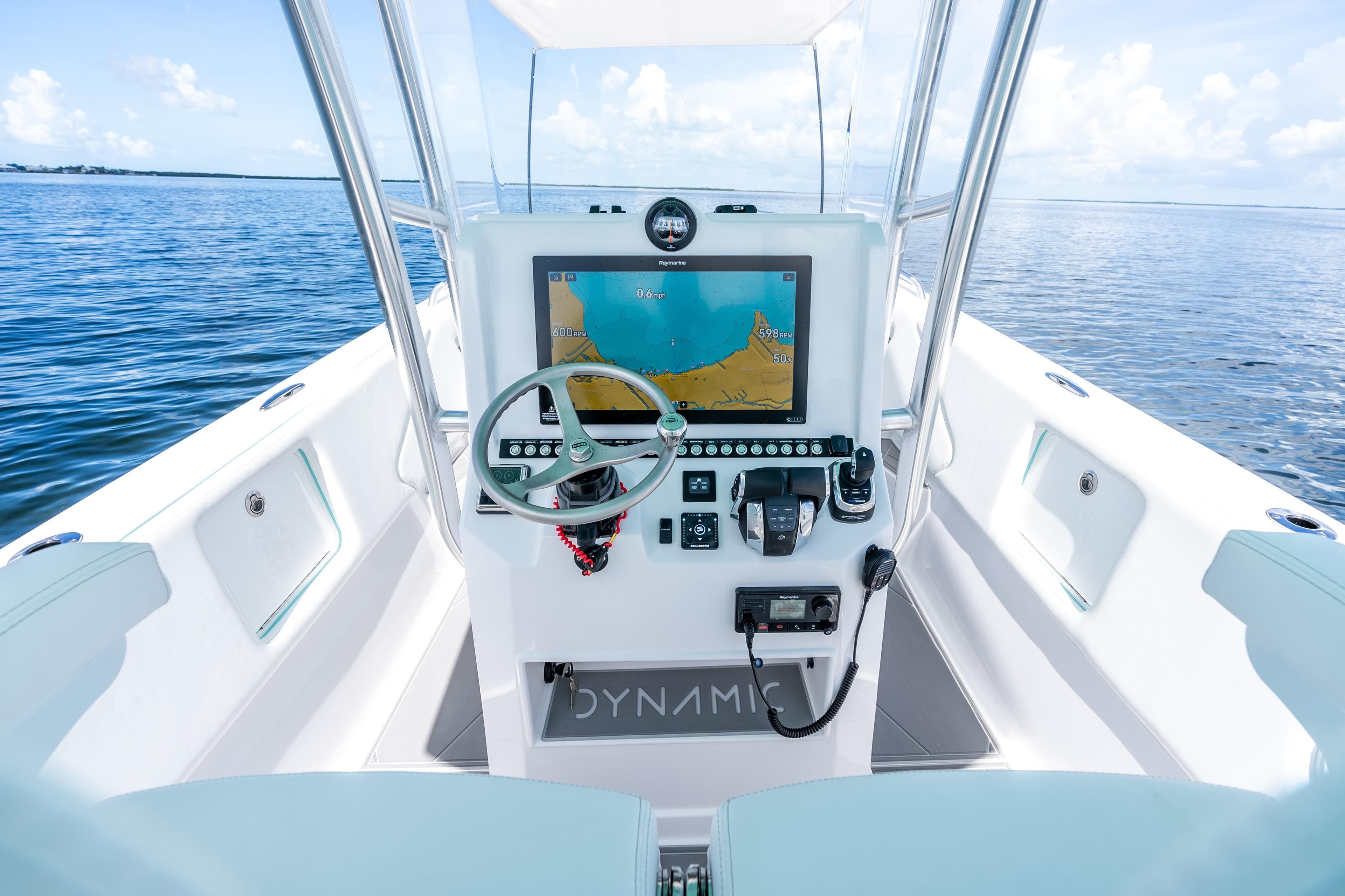 2024 Dynamic D-305V boat cockpit with advanced navigation system on open water.