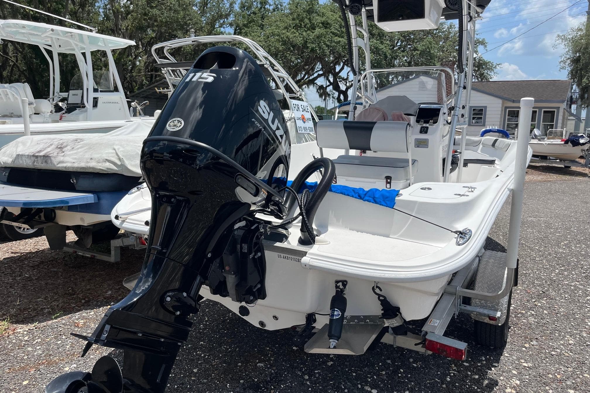 2022 K2 Marine boat with Suzuki 115 engine, displayed outdoors for sale.