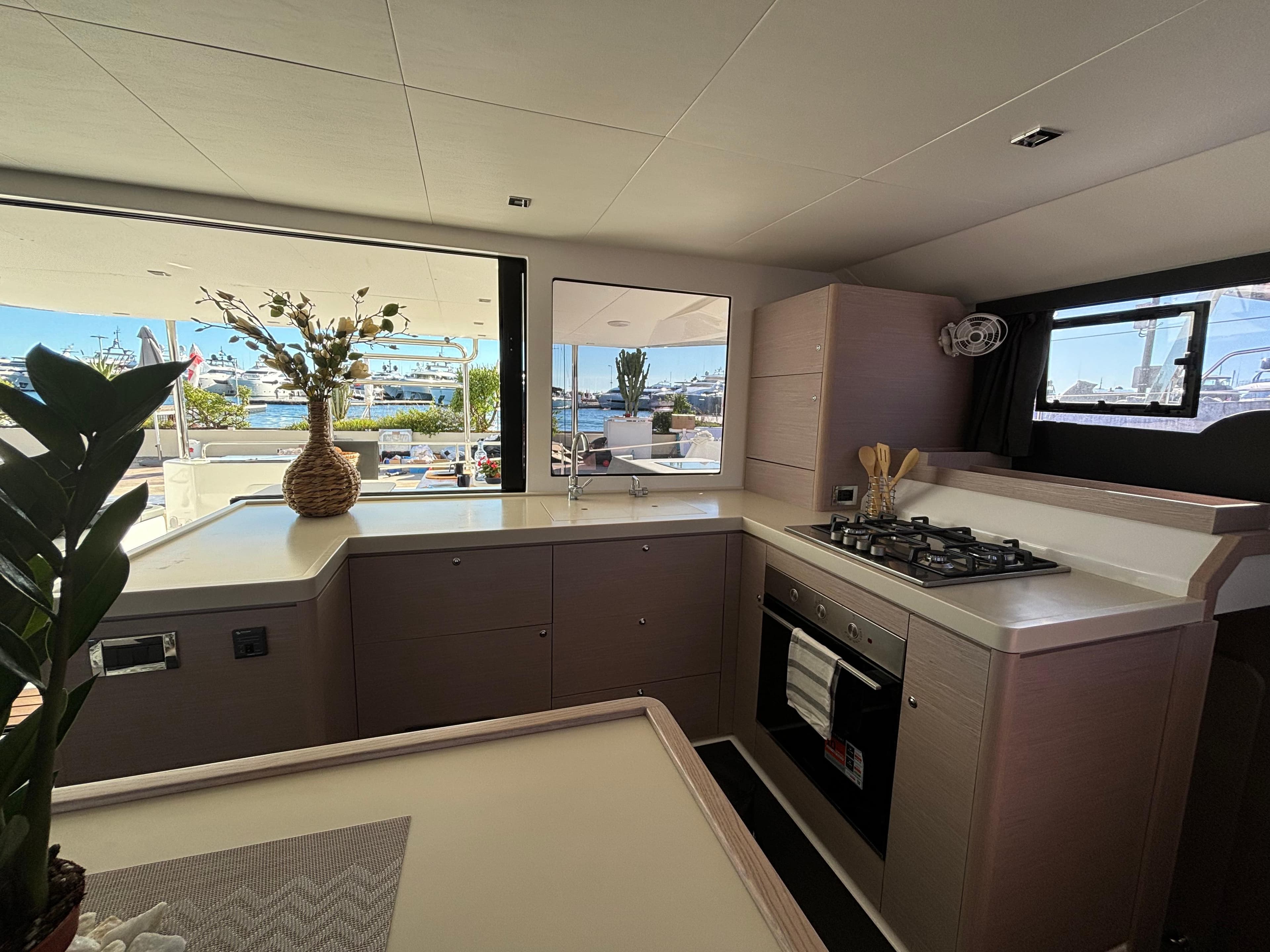 Luxurious kitchen interior of 2024 Dufour Catamarans 48 with modern appliances and scenic views.