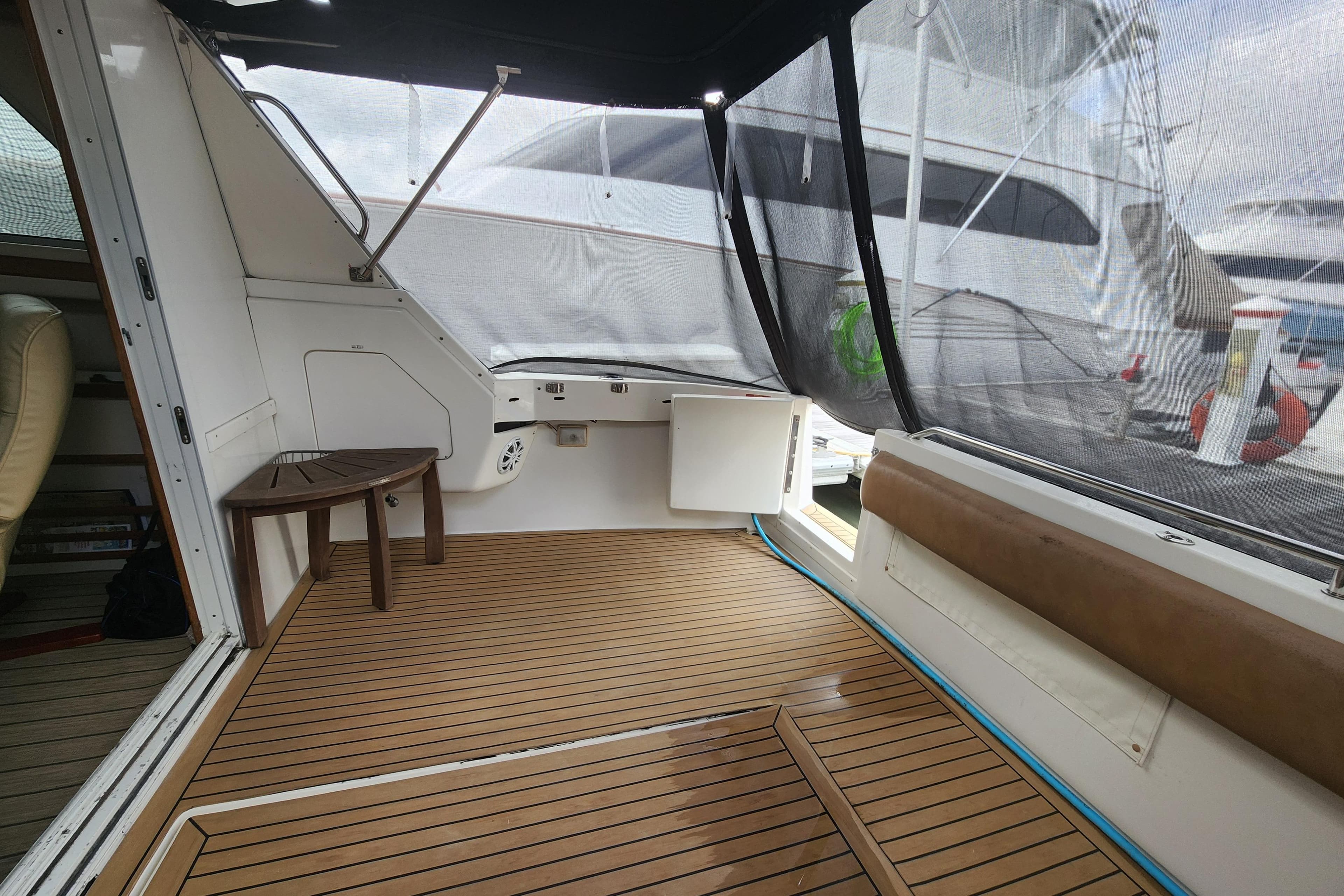 1996 Sea Ray 370 Sedan Bridge interior with wooden deck and seating area.