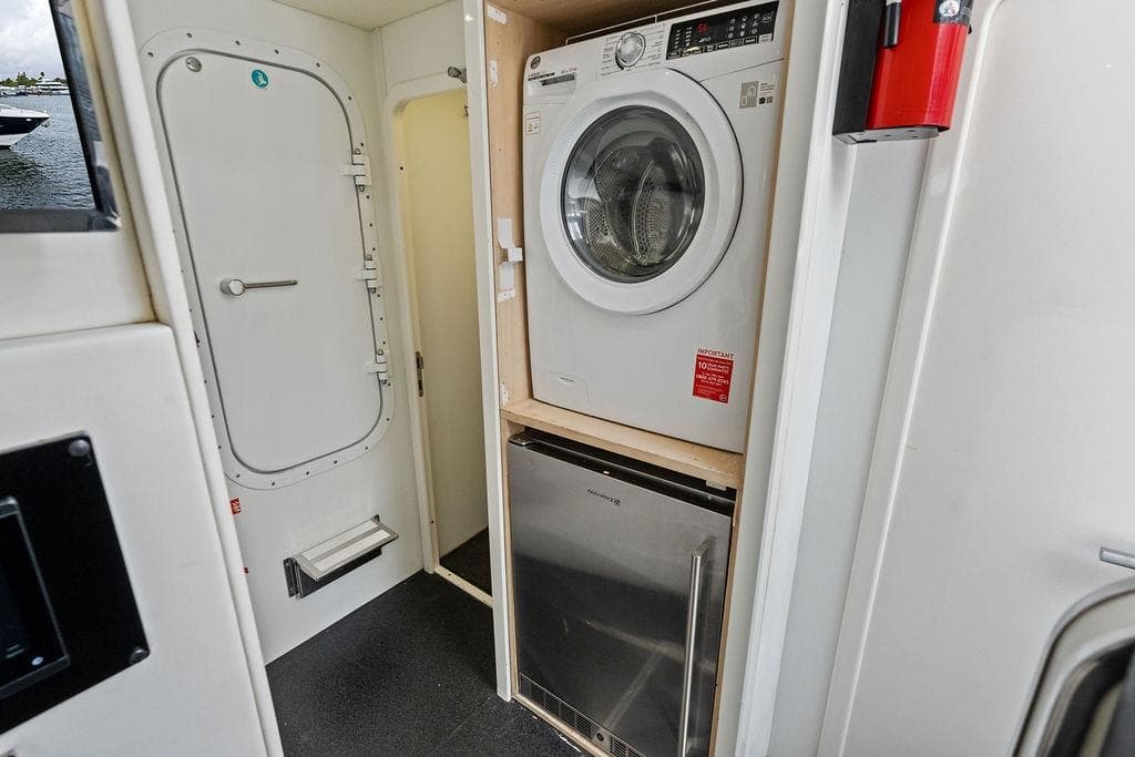 Laundry area on 2012 Sunseeker 88 Yacht with washer, dryer, and storage.