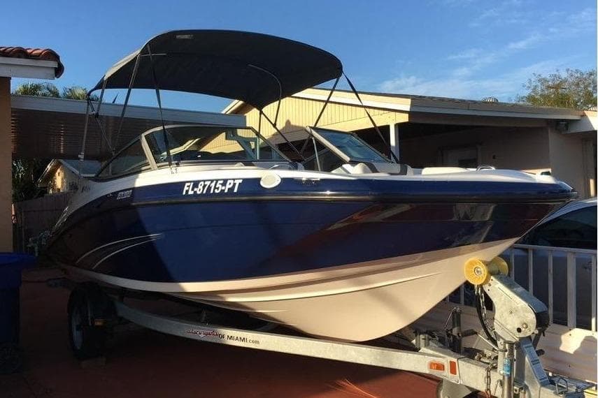 2014 Yamaha SX190 boat on trailer, blue hull, sunshade.