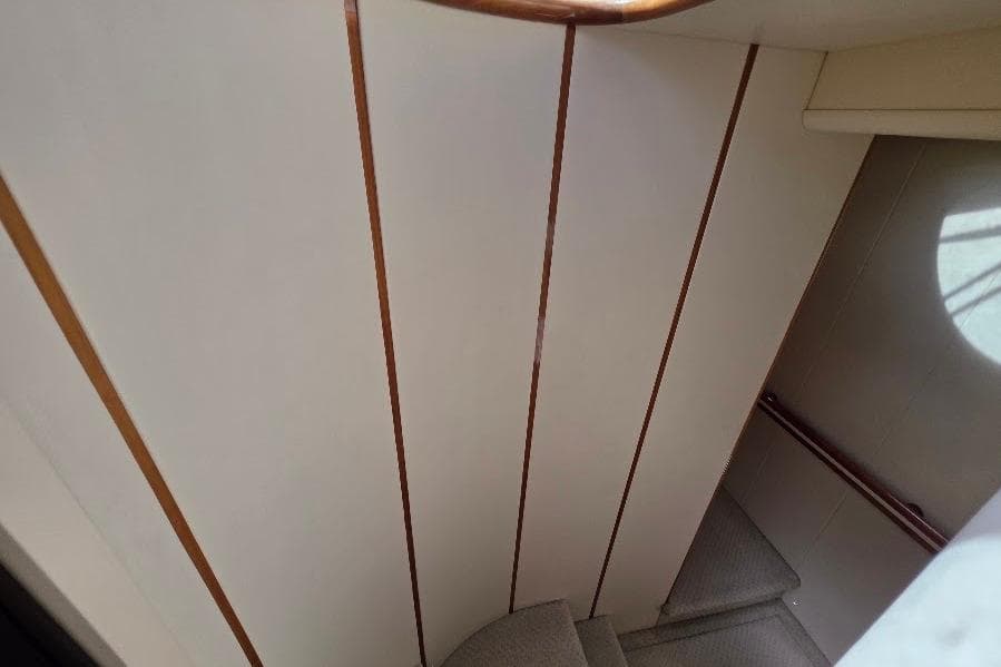 Staircase inside 2008 Neptunus Flybridge MY yacht with wooden accents.