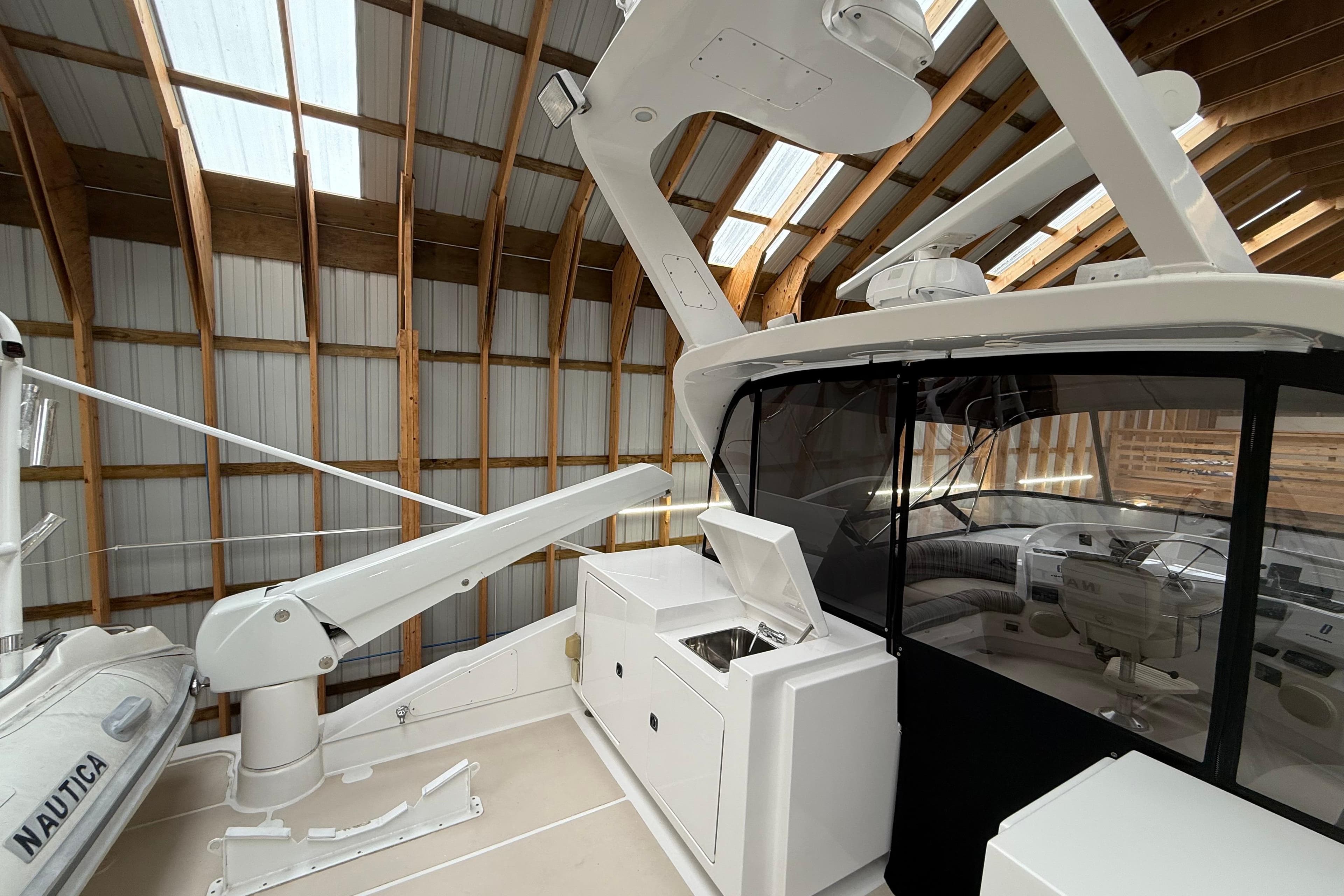 Northern Pacific 2000 motor yacht interior with modern equipment and sleek design in a wooden boathouse.