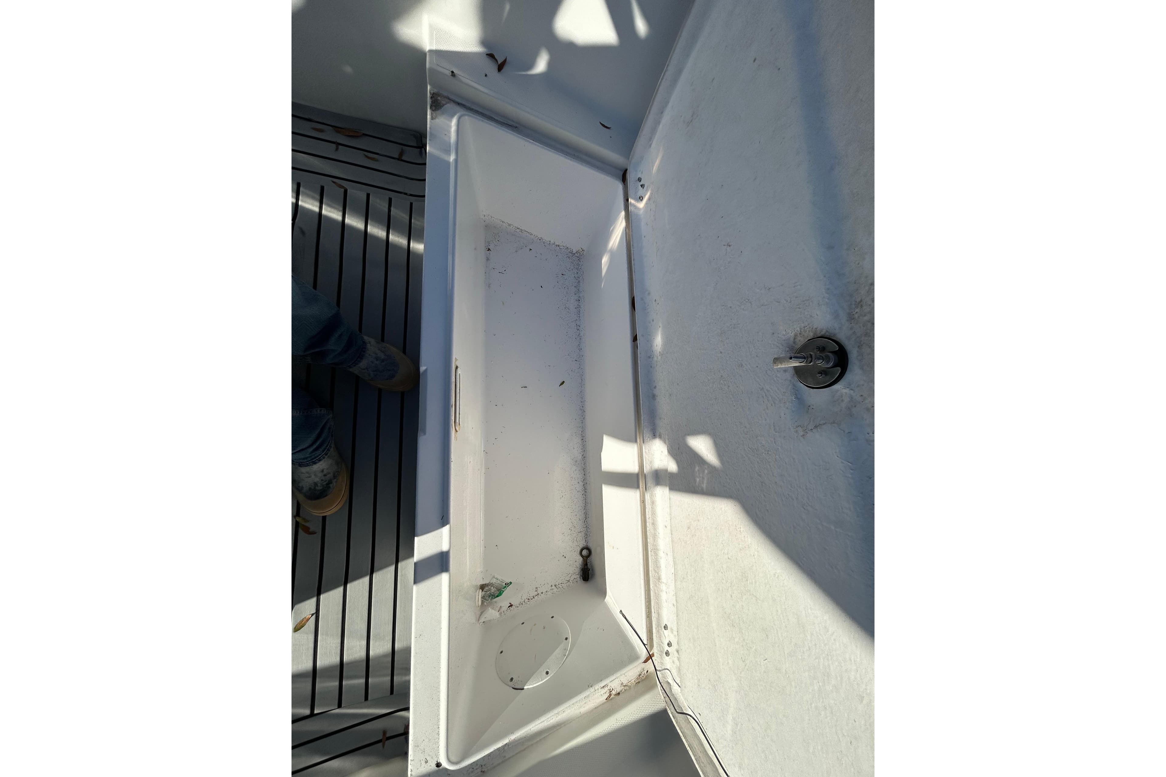 Open storage compartment on 2022 Clearwater 2300 boat deck.