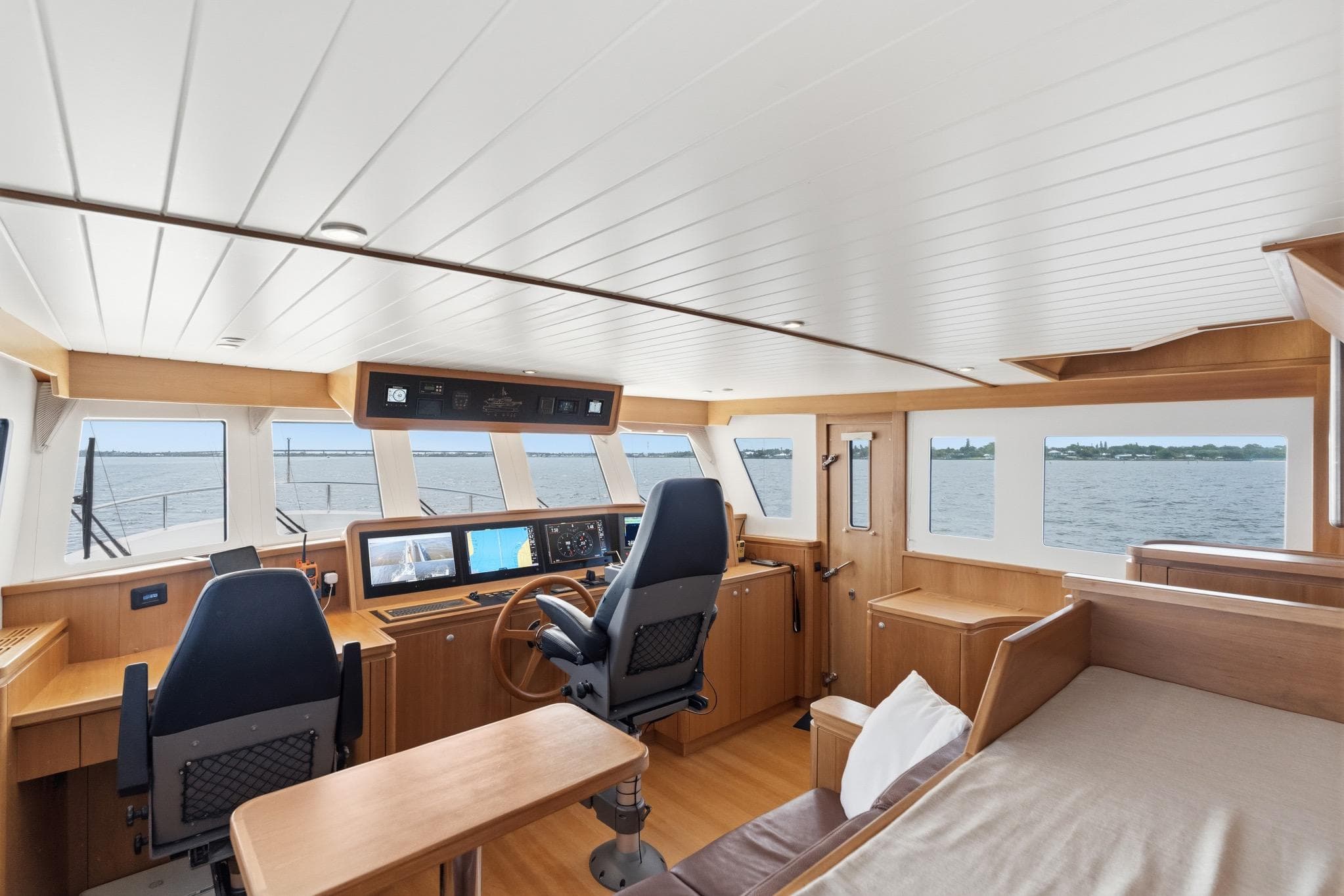 Pilothouse of 2022 Alm Trawler Delfino 64 with modern navigation equipment and panoramic windows.
