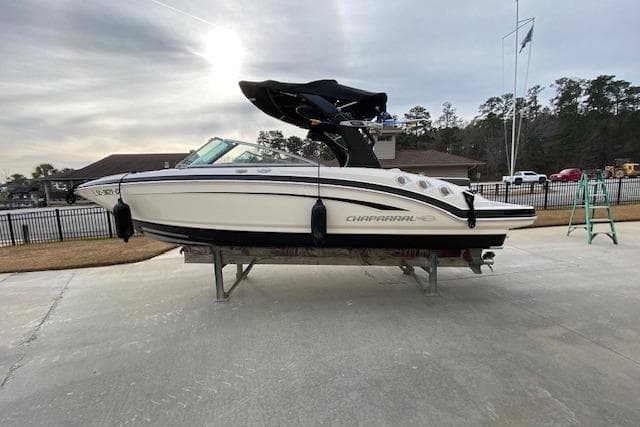 2013 Chaparral 226 SSi boat on display, outdoor setting, overcast sky.
