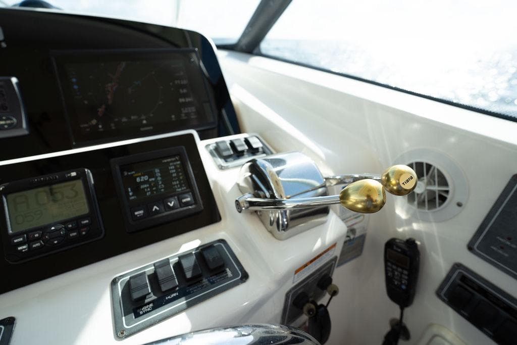 Control panel of a 2005 Tiara Yachts 4200 Open, featuring navigation and throttle controls.