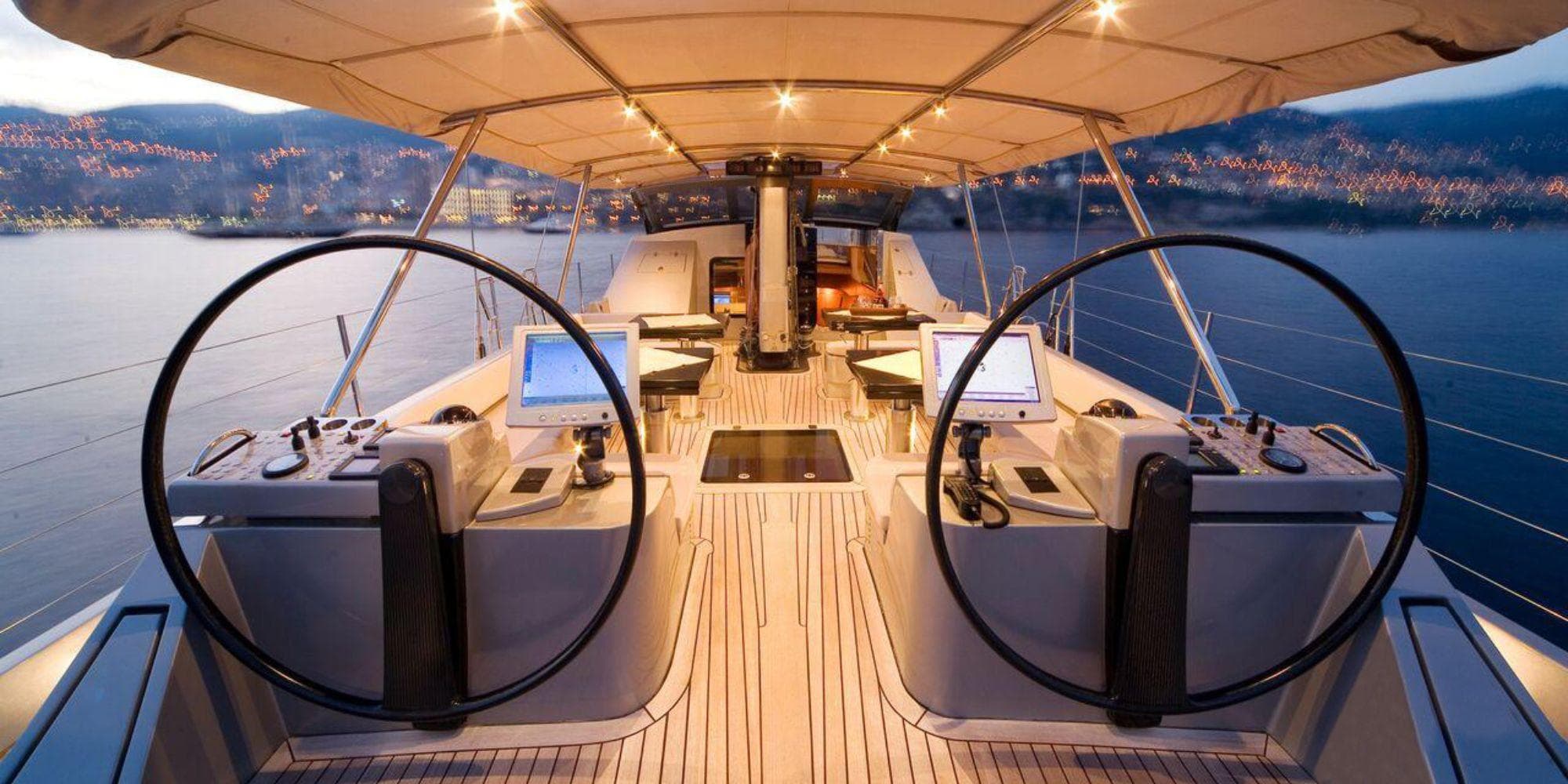 Luxurious 1994 CMN 39 Modern Schooner yacht interior with dual steering wheels at sunset.