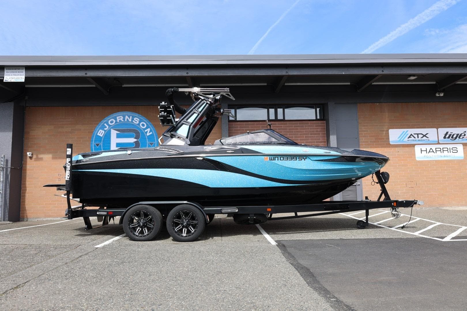 2021 Centurion Fi23 boat on trailer, parked outside Bjornson building.