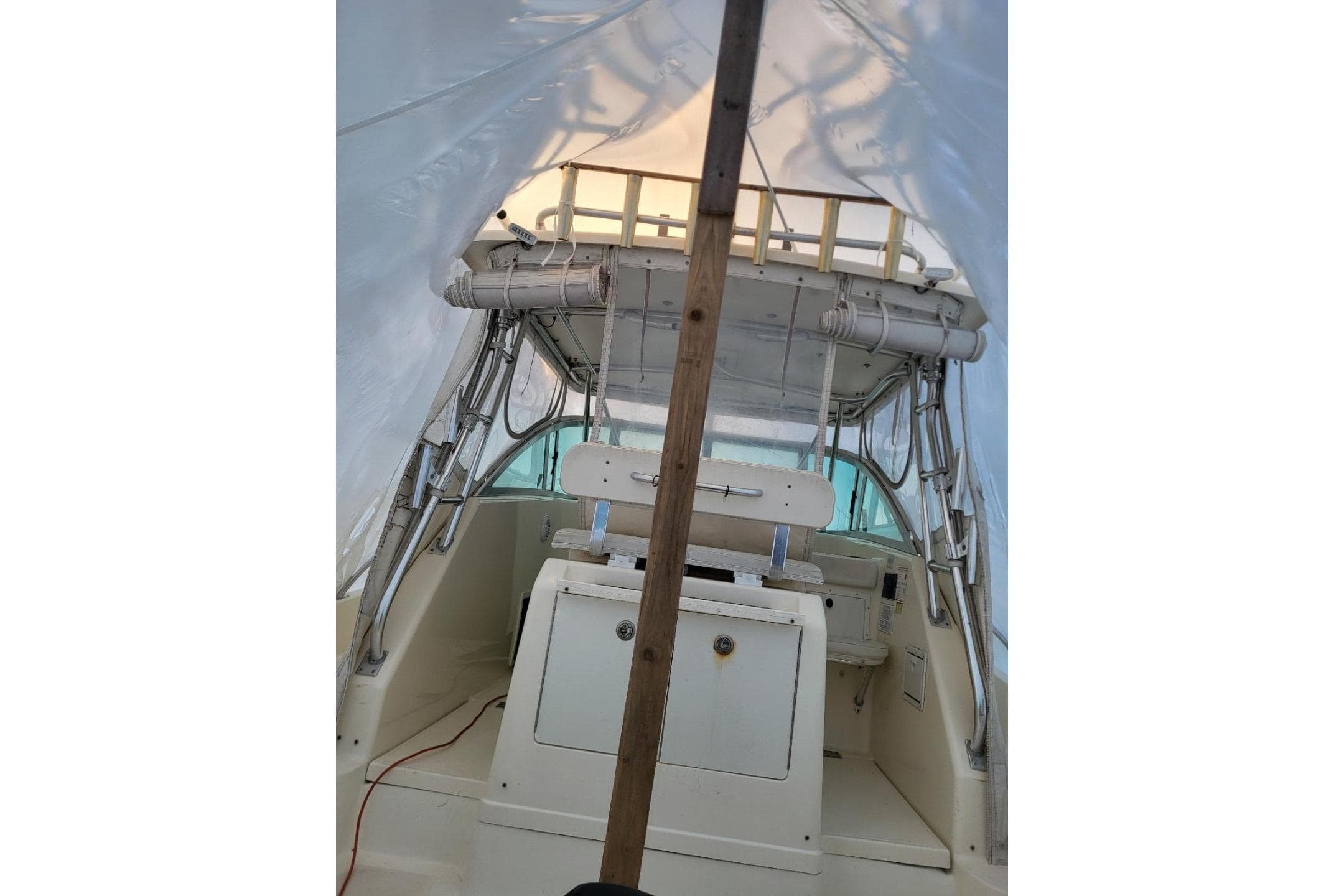 2000 Pursuit 3070 Offshore Center Console boat interior under protective cover.