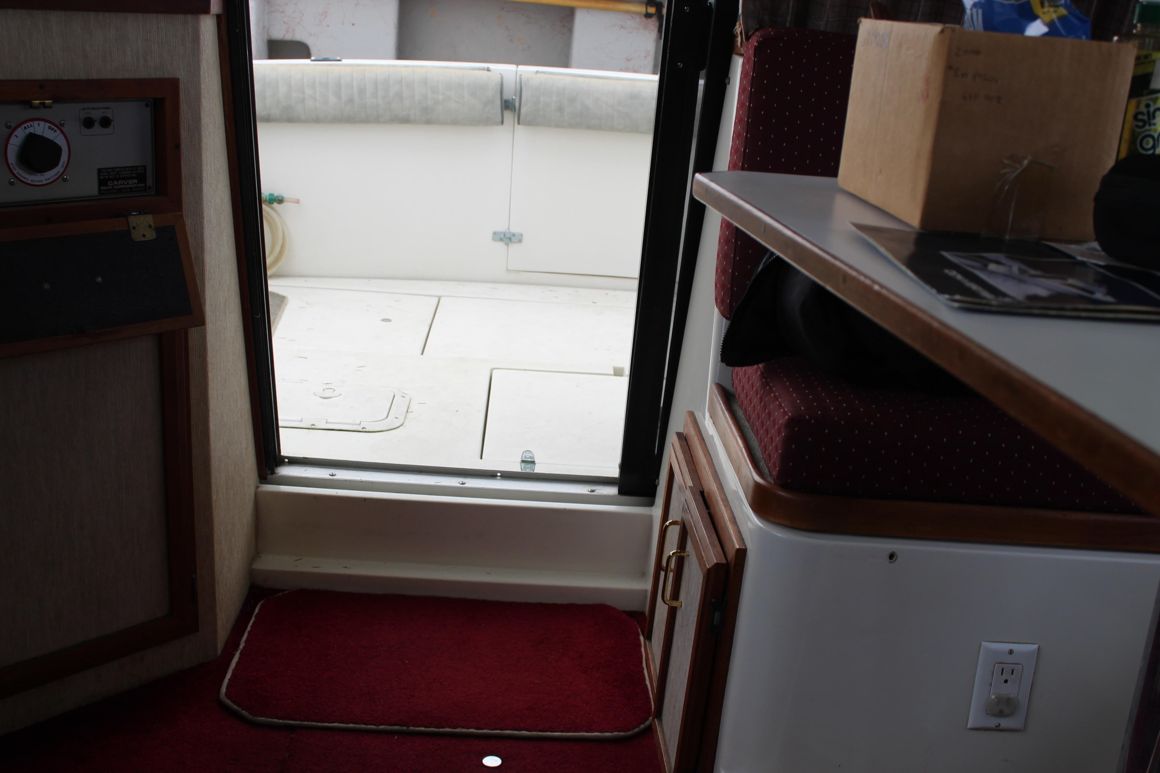 Interior view of 1985 Carver 32 Convertible boat, showing cabin entrance and seating area.