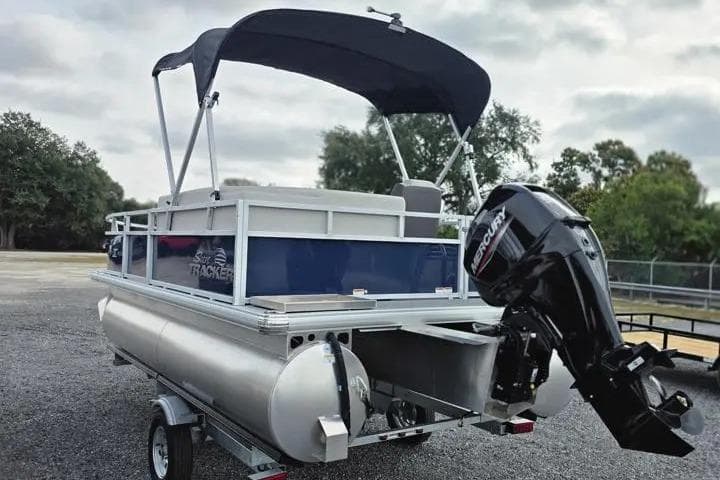 2026 Sun Tracker Bass Buggy 16 XL Select pontoon boat with Mercury outboard motor.