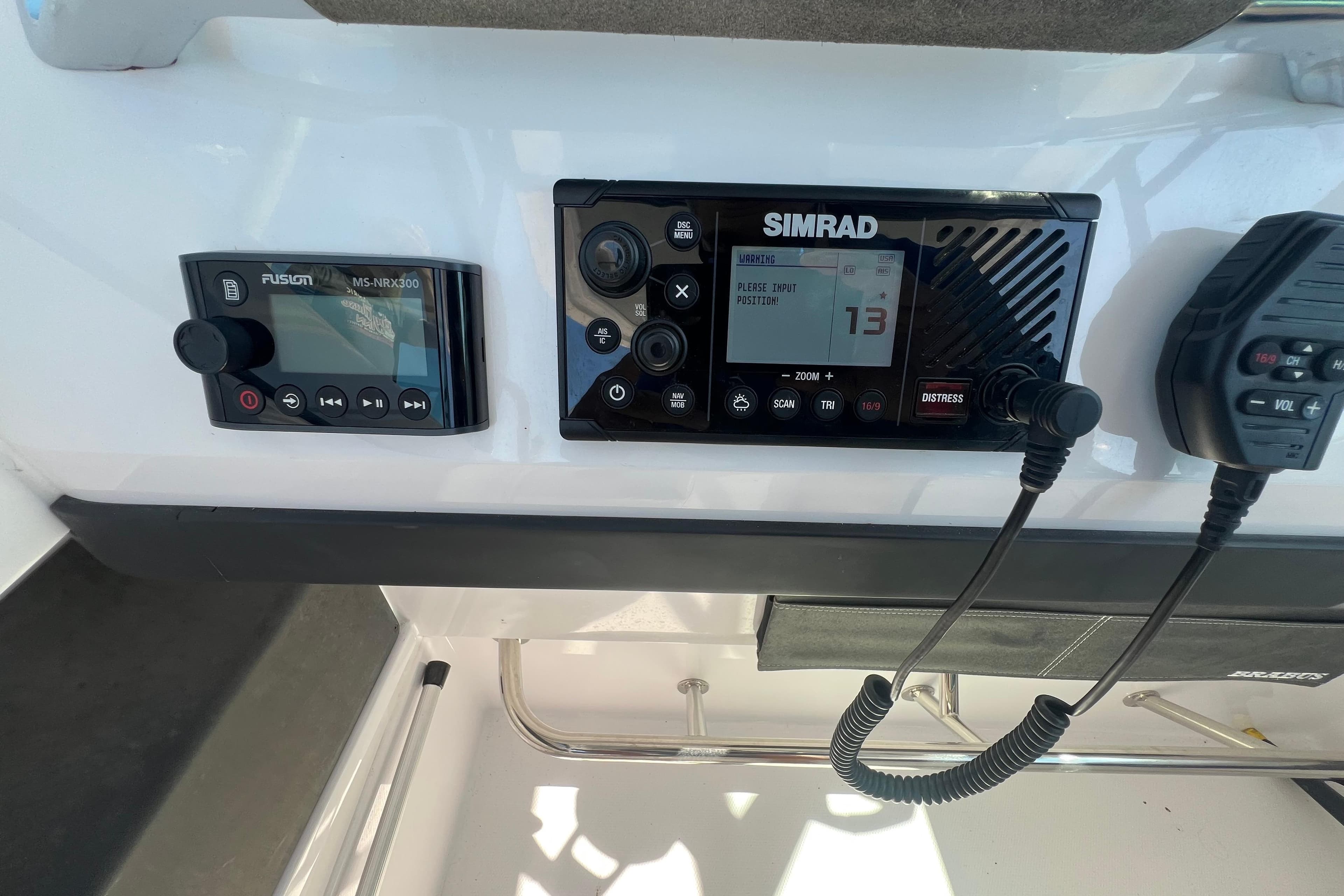Control panel of a 2021 Axopar 28 boat featuring Simrad and Fusion devices.