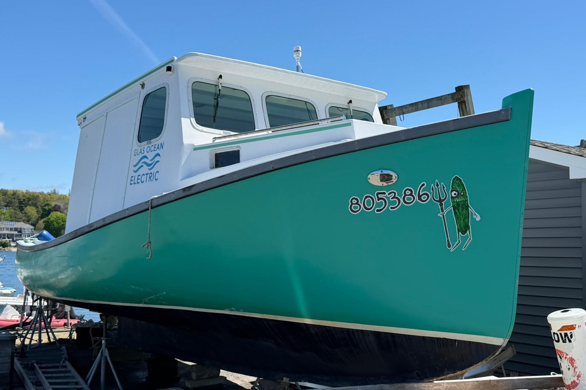 Electric 1984 Custom Cape Islander boat with unique green hull design.