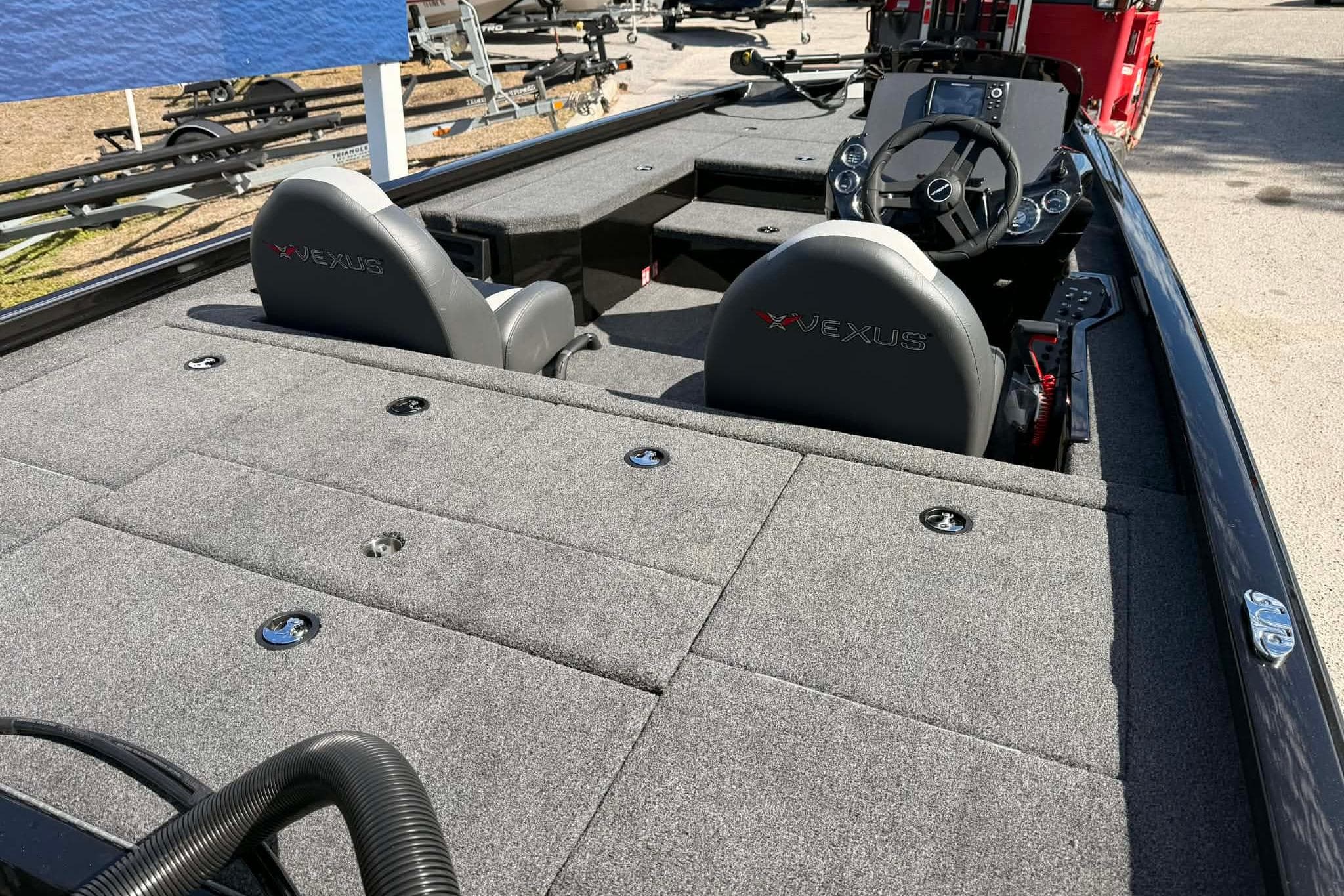 2026 Vexus Defender 181 boat interior with gray seating and spacious deck layout.