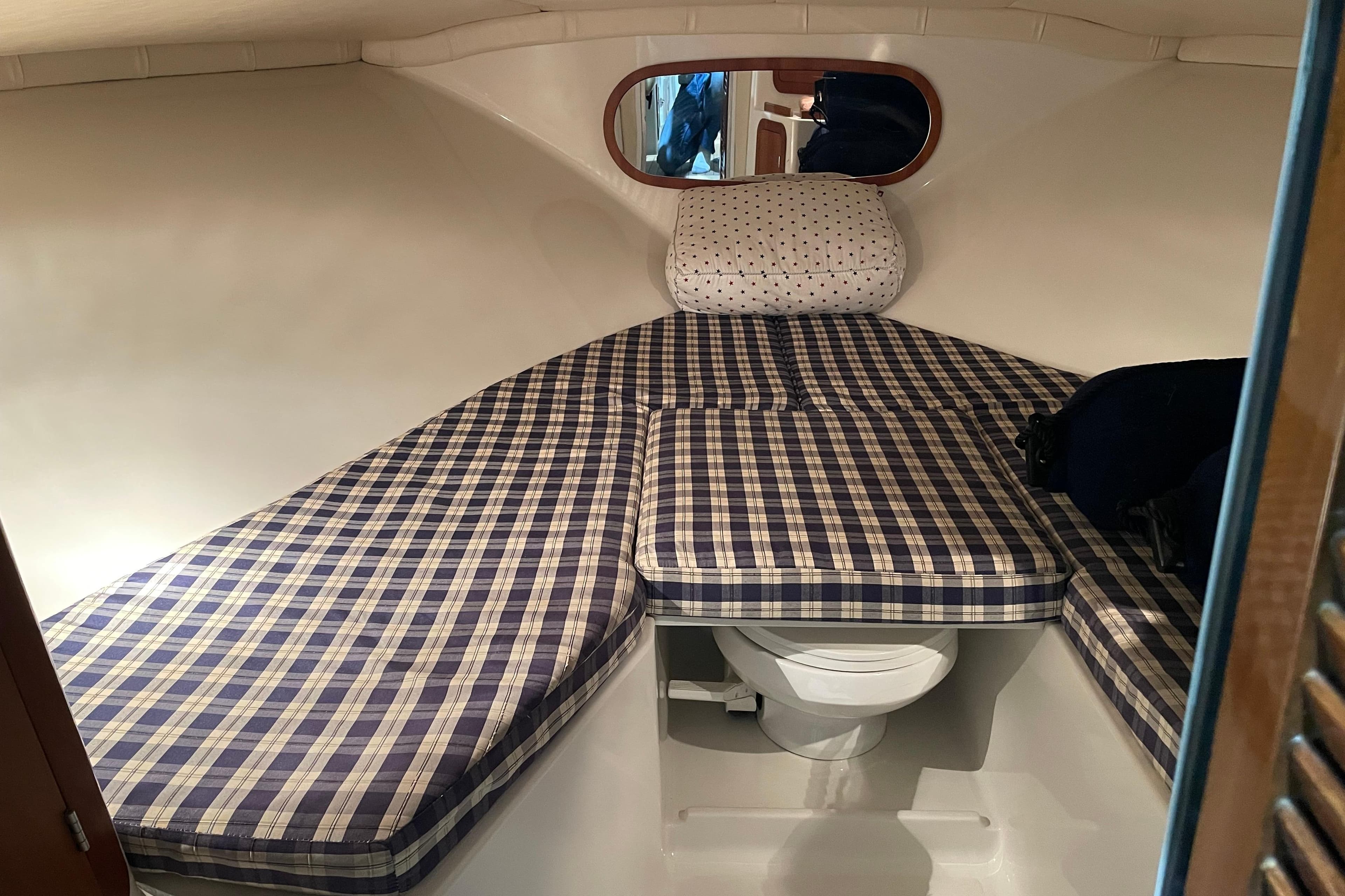 2003 Chris-Craft Corsair 28 Heritage Edition cabin with plaid cushions and compact toilet.