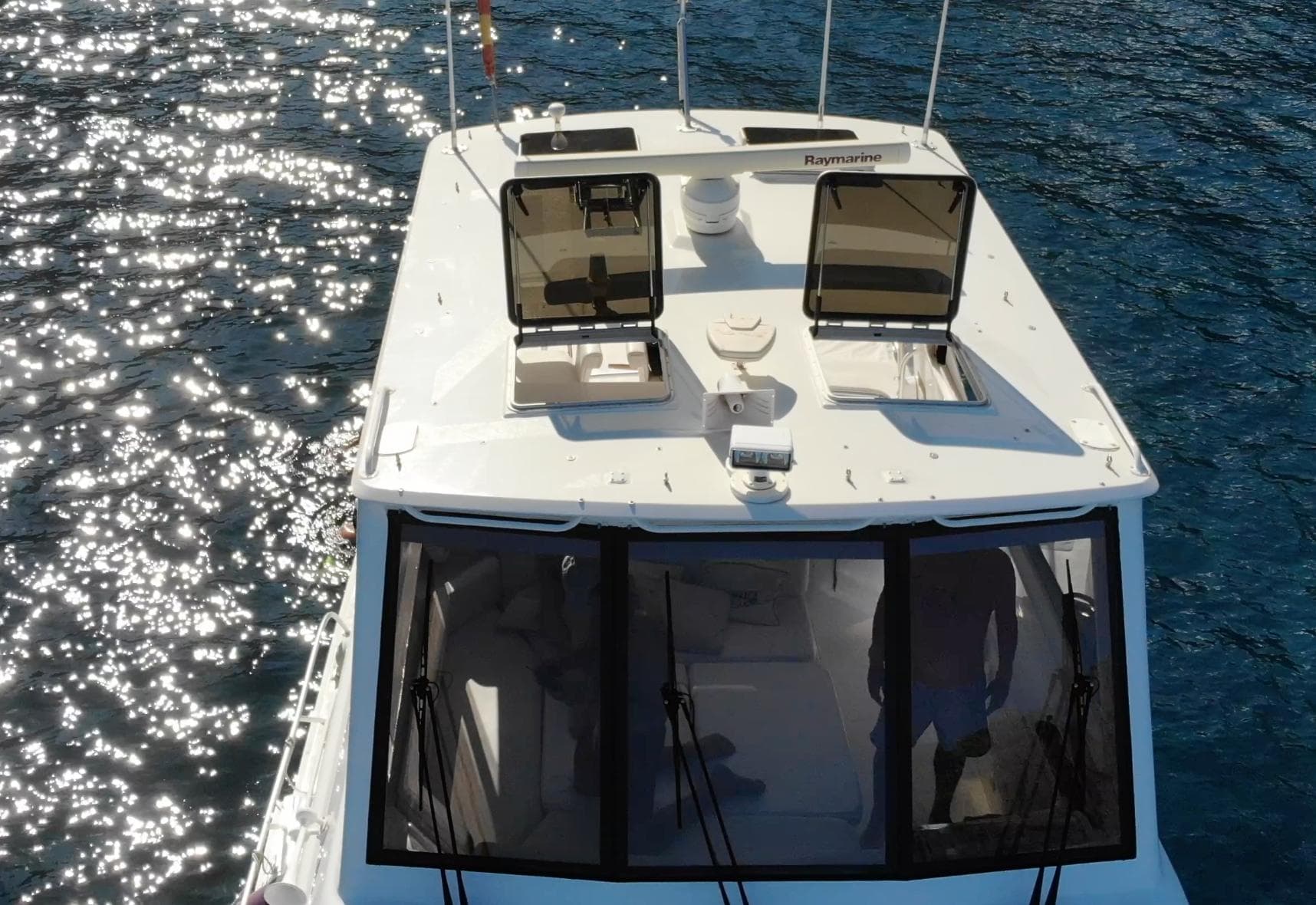 2004 Bertram 510 yacht on sparkling water, aerial view.