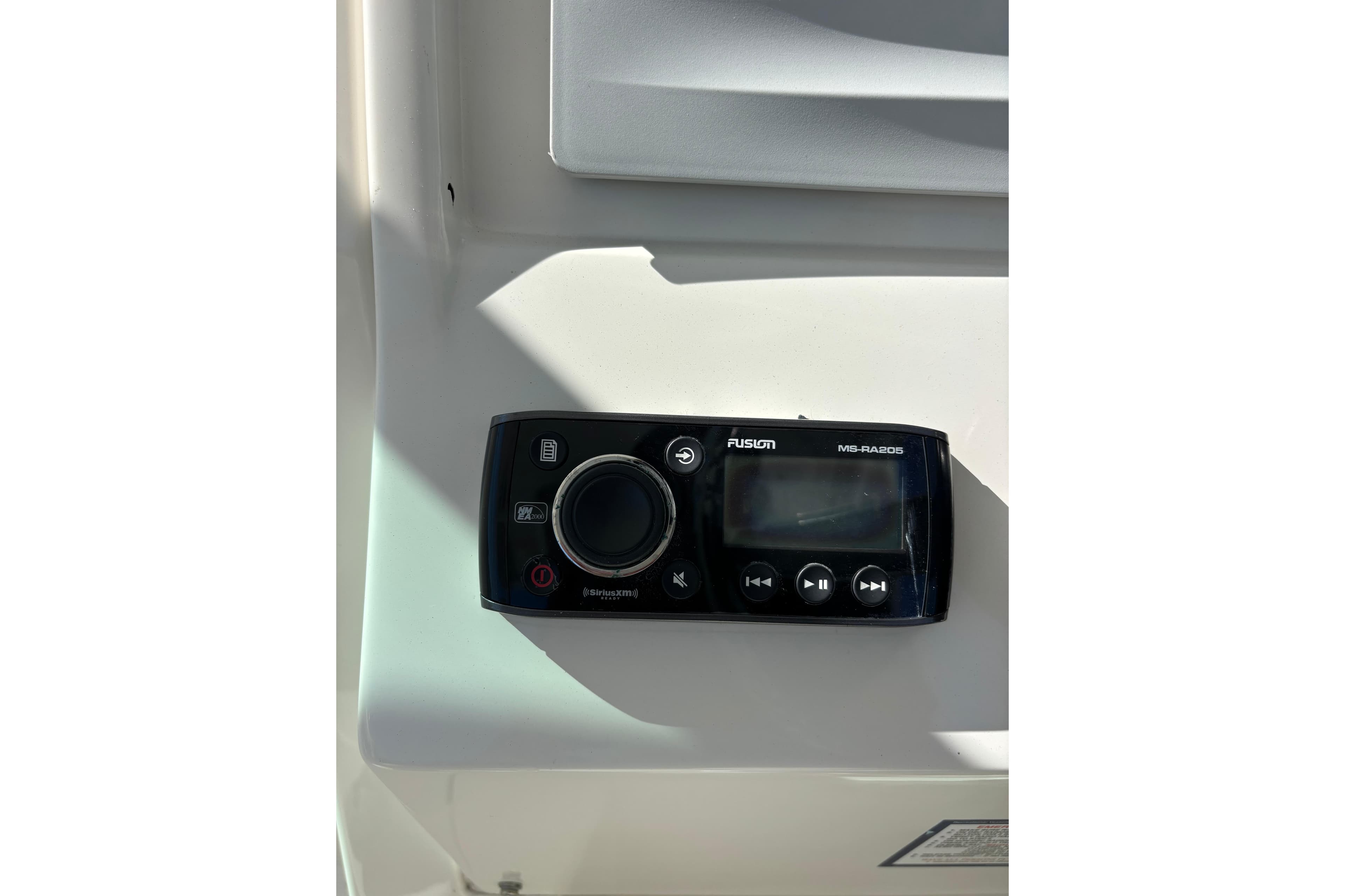 Fusion MS-RA205 marine stereo on 2015 Sailfish 275 DC boat dashboard.