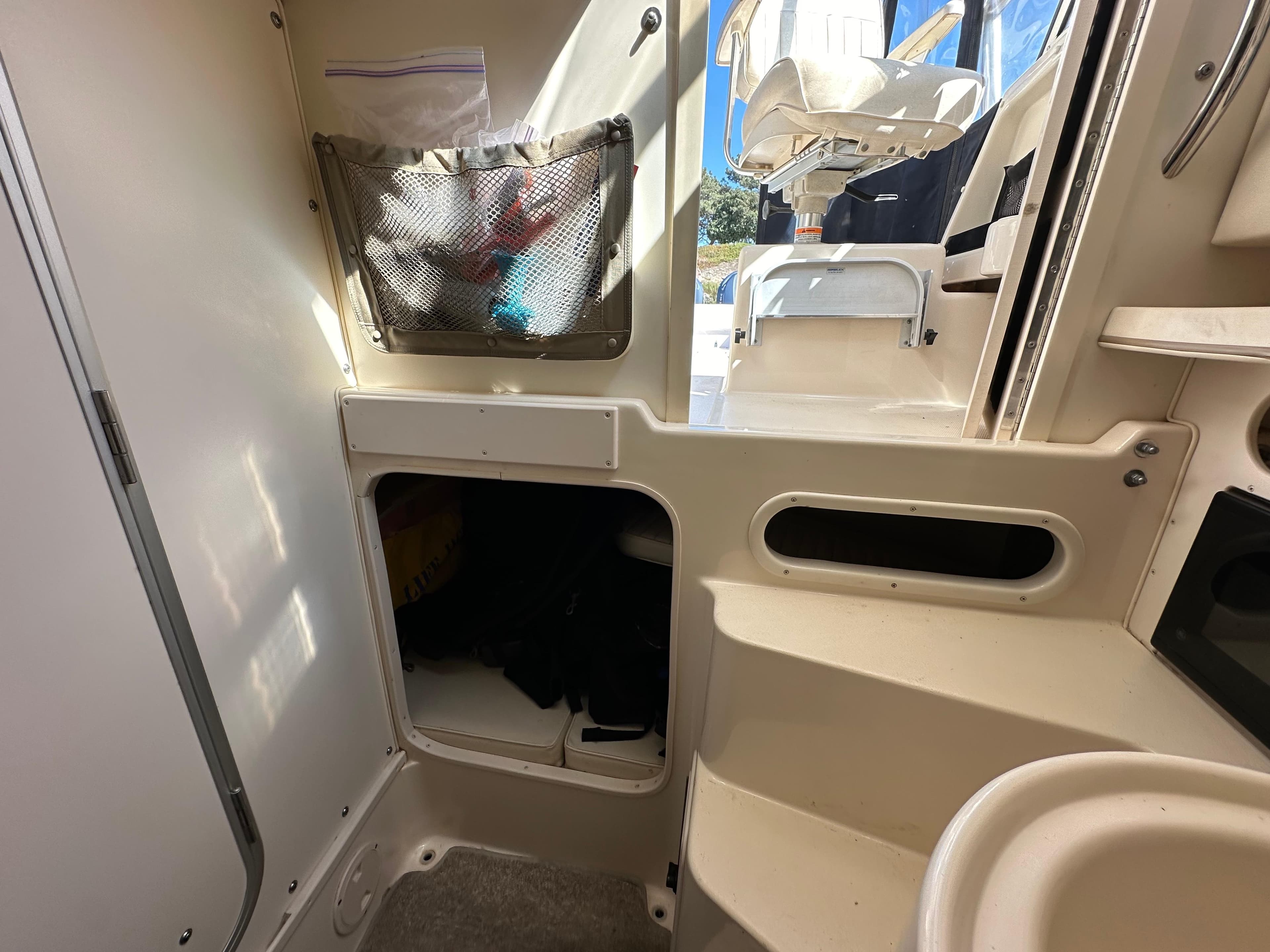 Interior of 2002 Grady-White 282 Sailfish boat, featuring storage compartments and seating area.