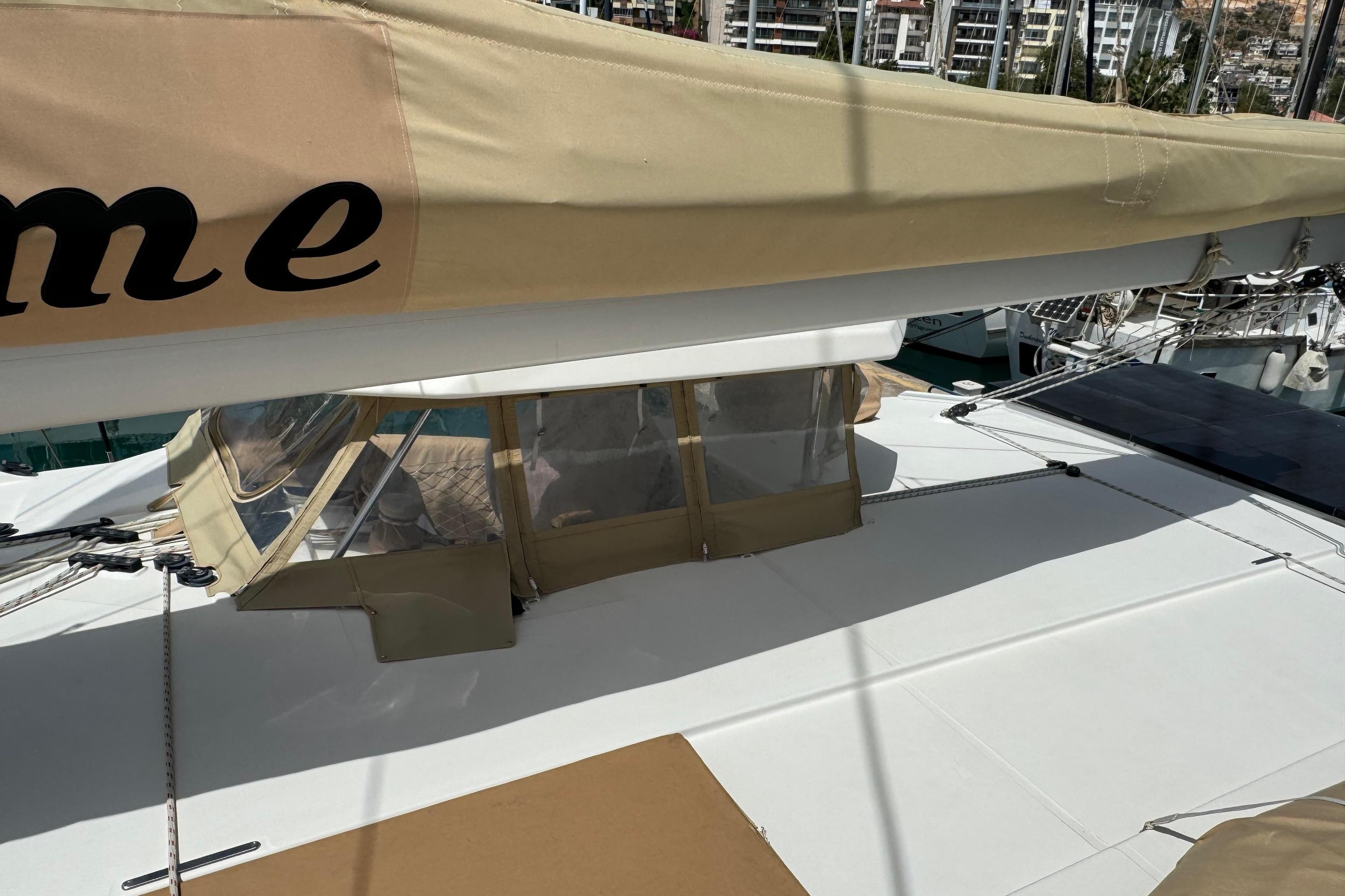 Sailing yacht Leopard 45, 2019 model, with beige sail cover in marina.