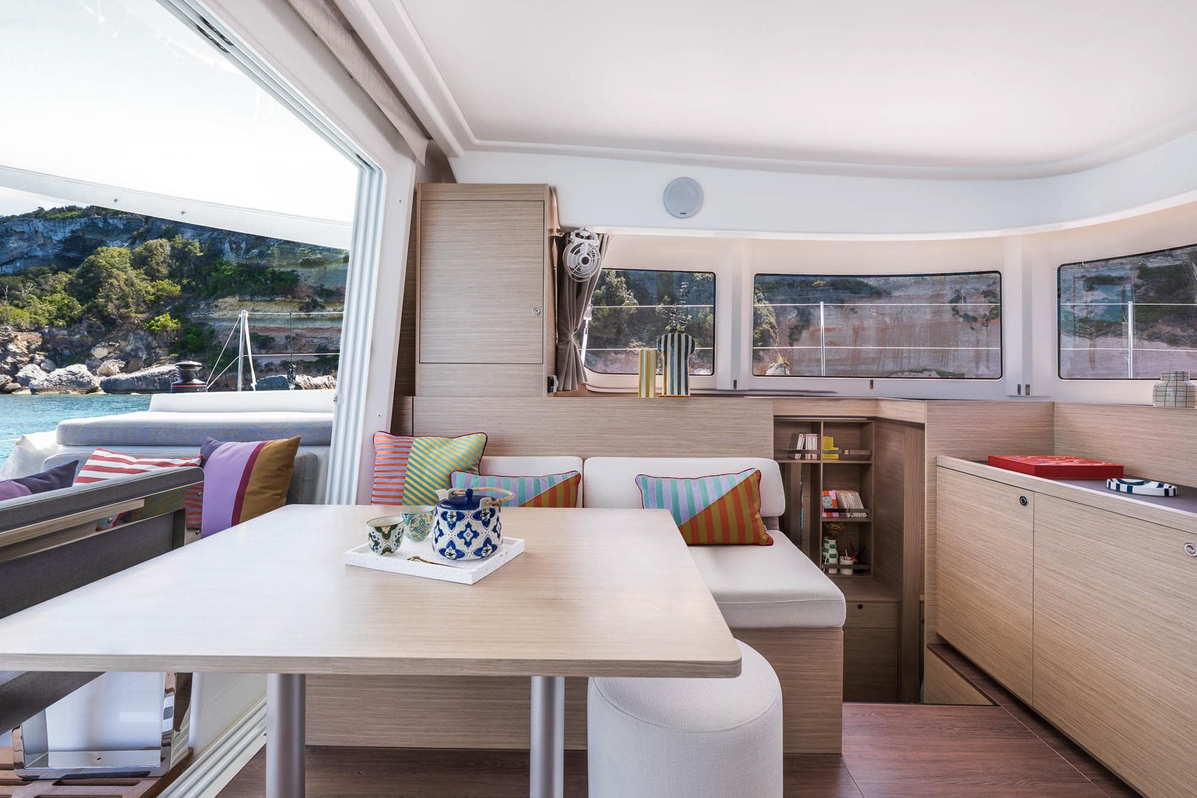 Modern interior of 2025 Lagoon 38 catamaran with scenic ocean view.