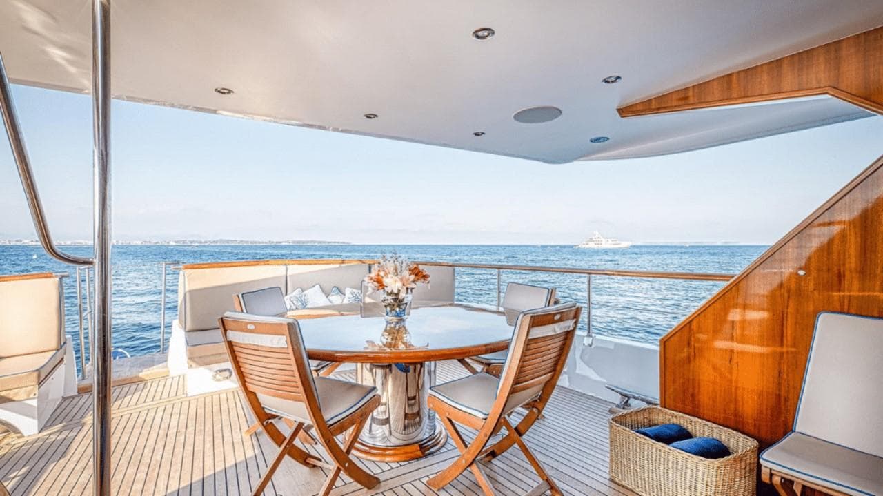 Luxurious 1966 Chantier de l’Esterel 28M yacht deck with elegant seating and ocean view.