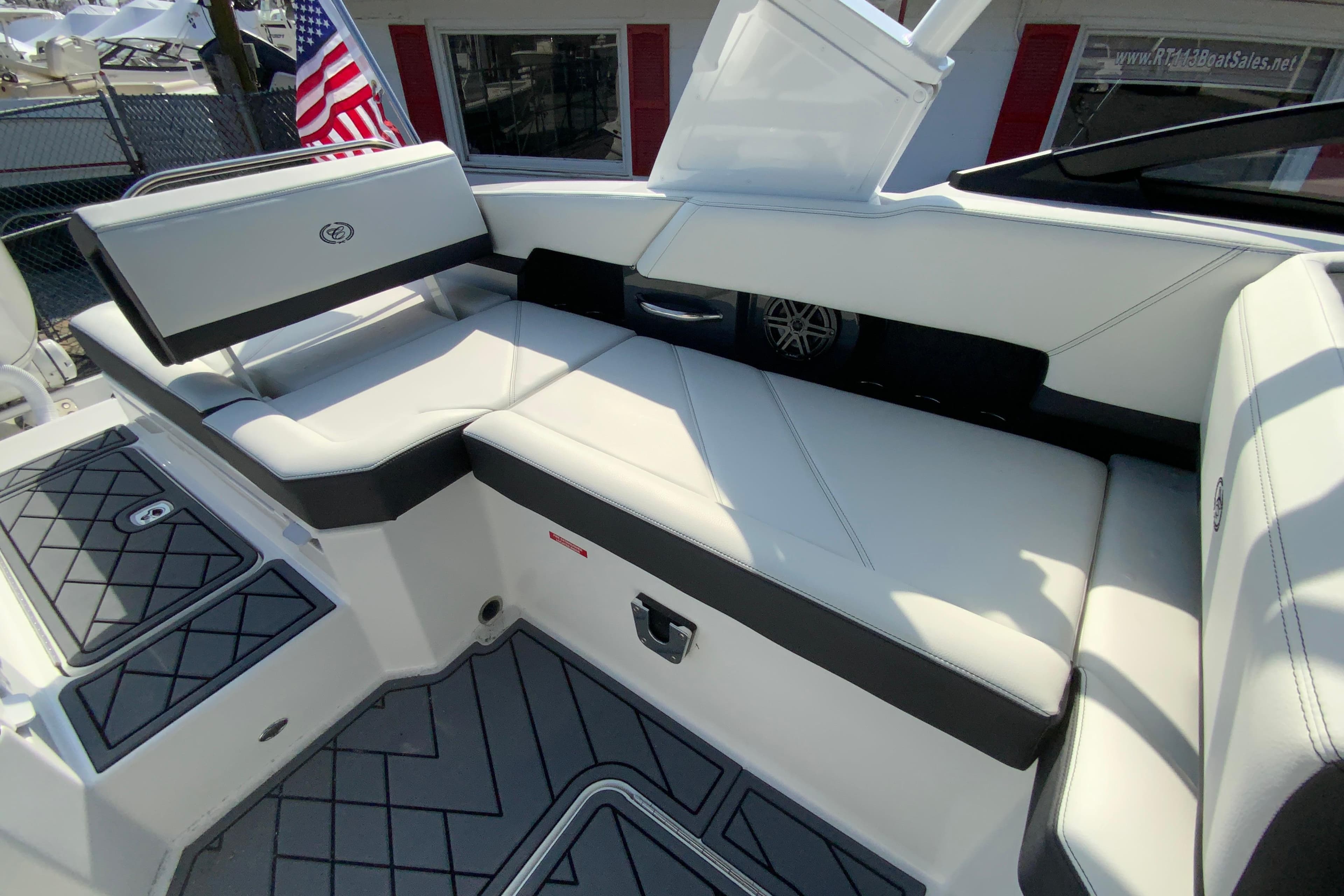 2026 Cobalt R6 Outboard boat interior with white seating and American flag.